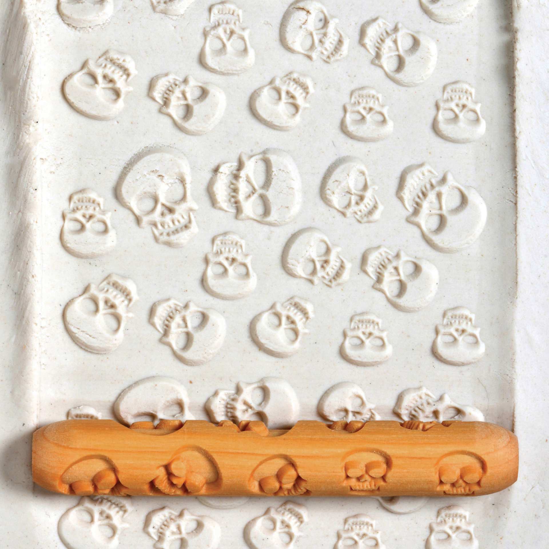 MKM Pottery Tools Hand Roller - Skulls applied to clay