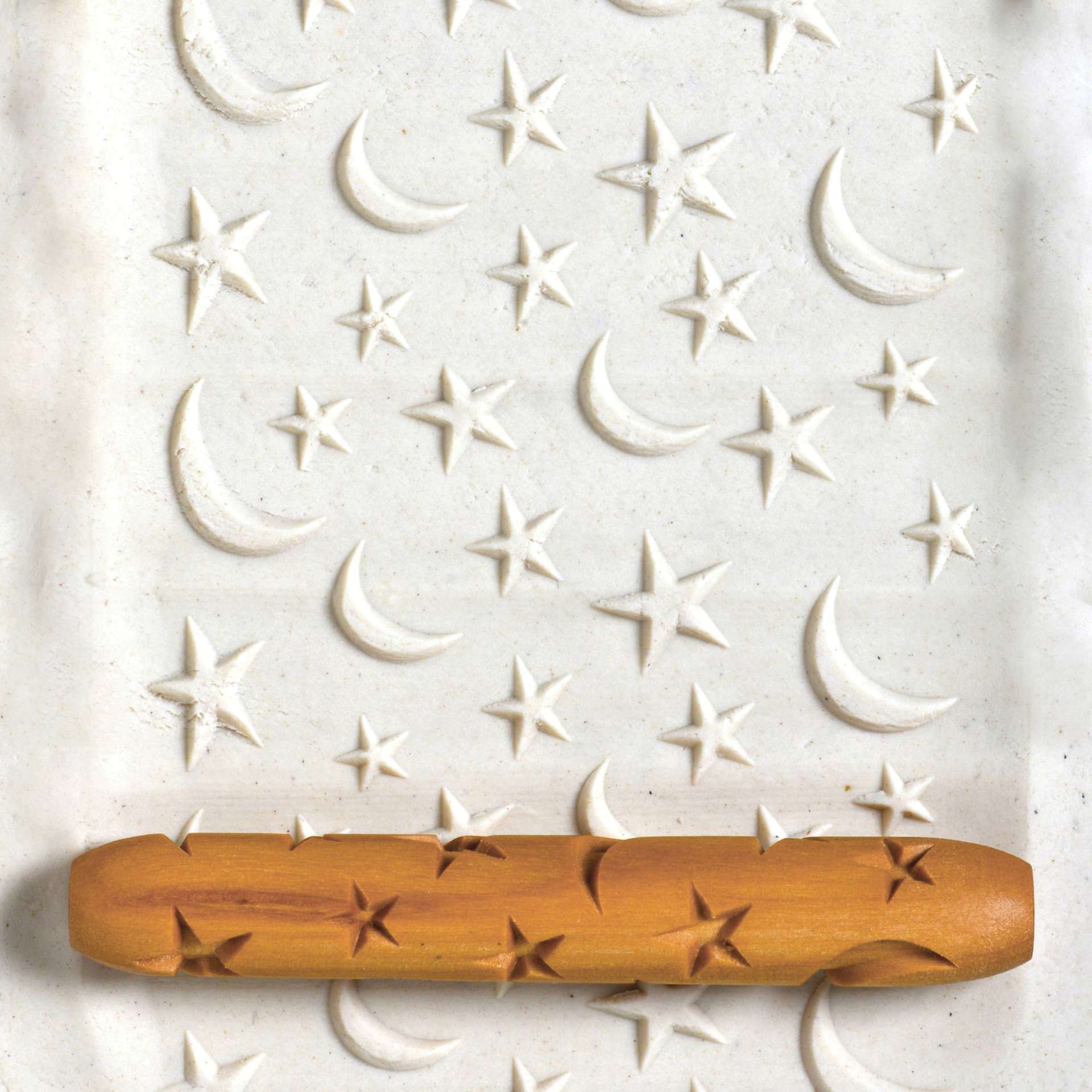 MKM Pottery Tools Hand Roller - Stars & Moons applied to clay
