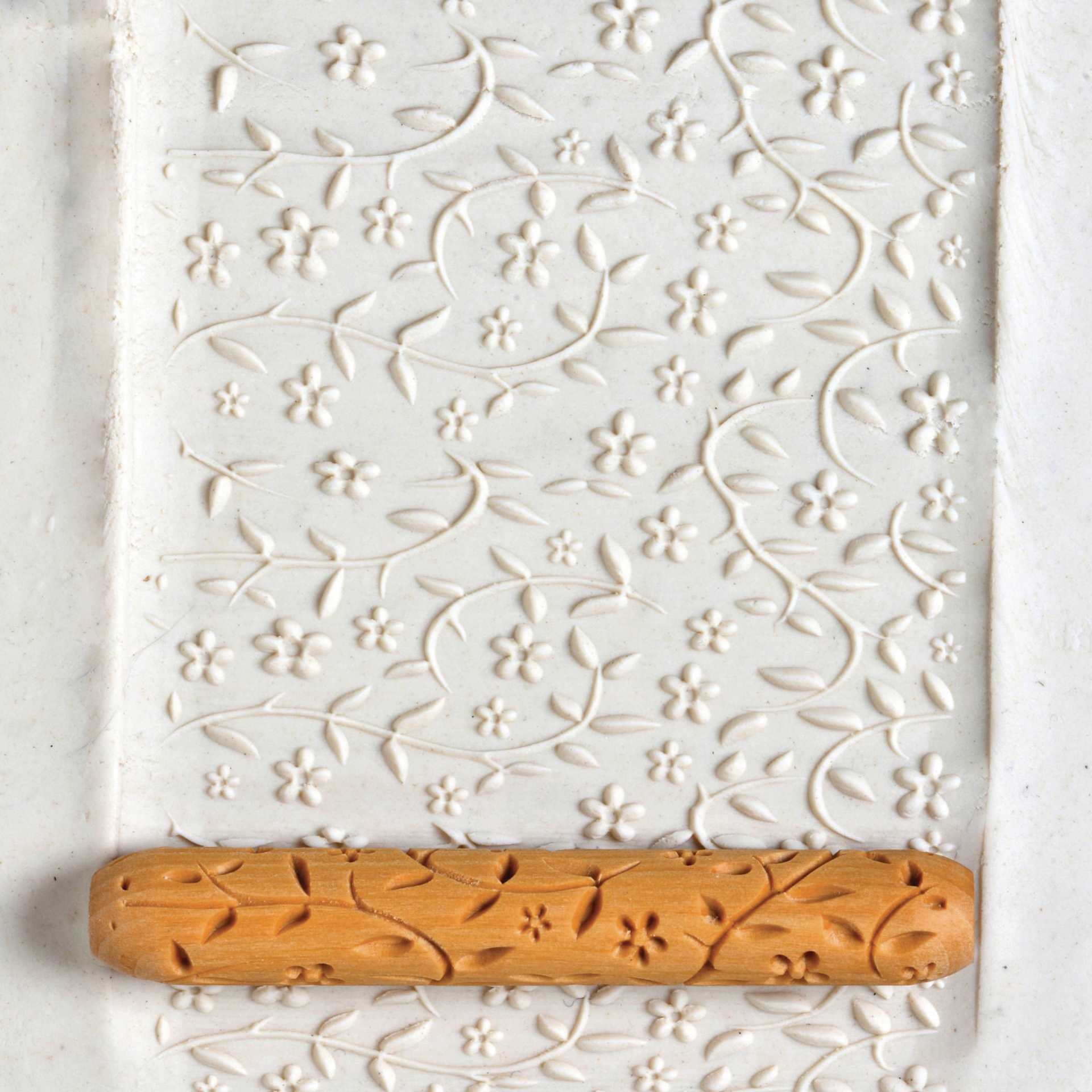 MKM Pottery Tools Hand Roller - Laura's Flora applied to clay