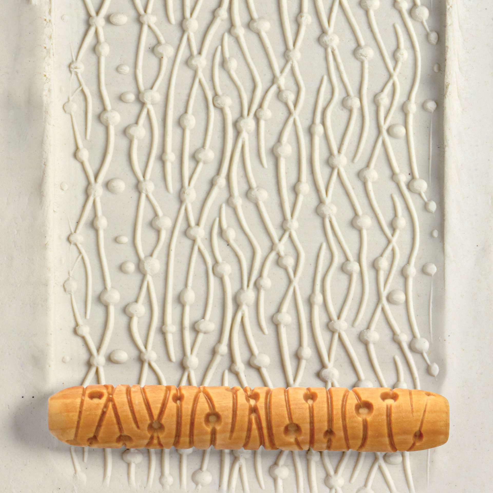 MKM Pottery Tools Hand Roller - Dots and Lines applied to clay