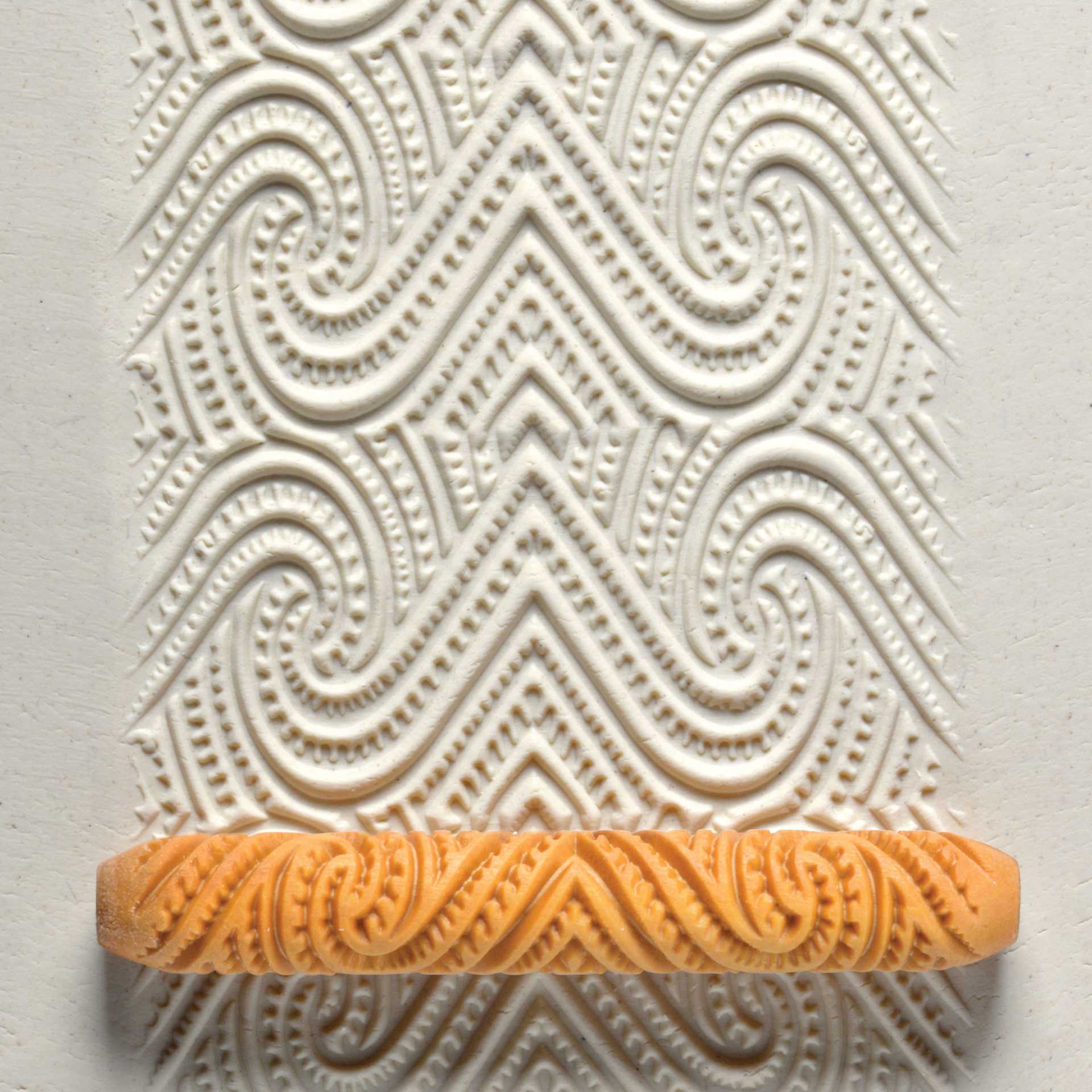 MKM Pottery Tools Hand Roller - Maori Spiral applied to clay