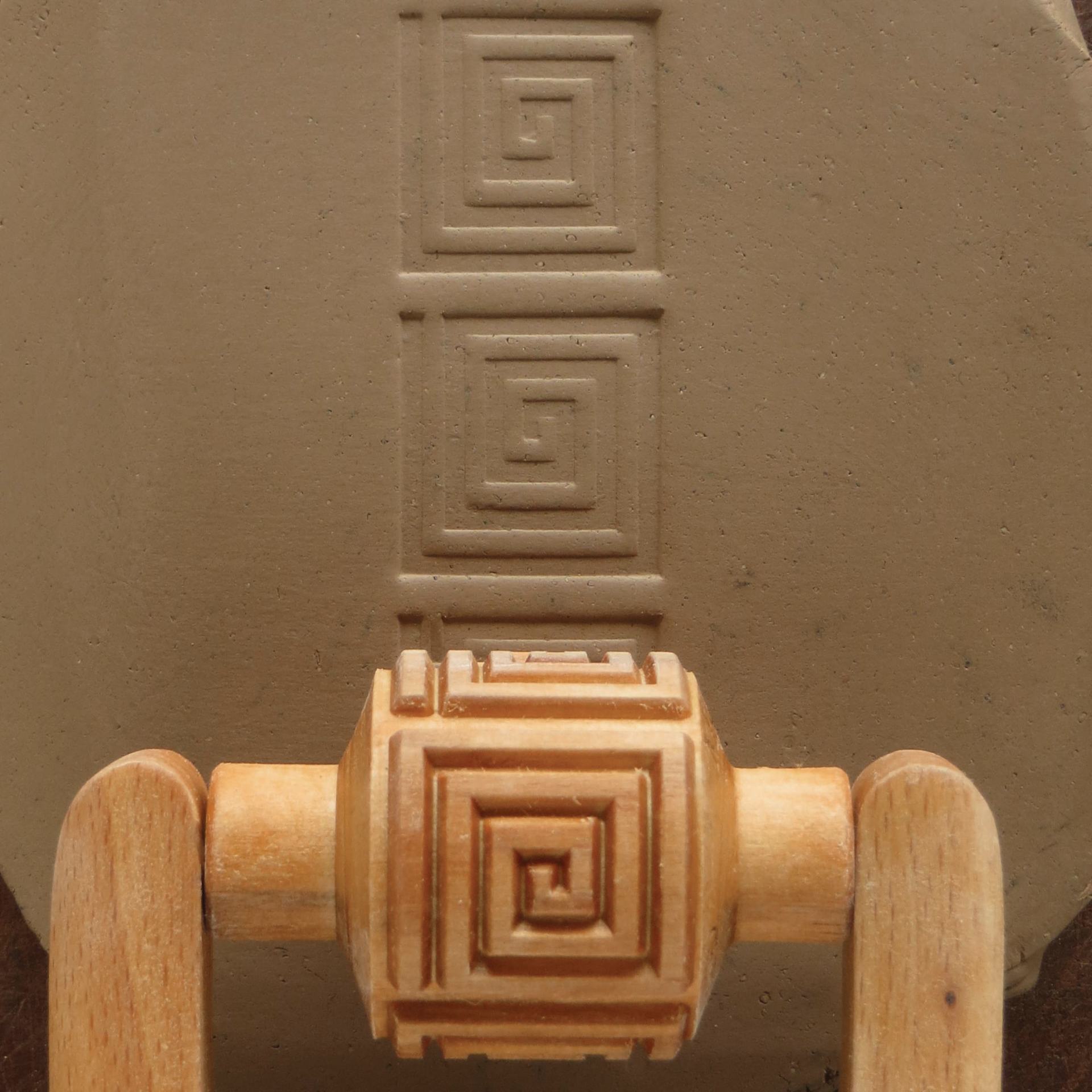 MKM Pottery Tools Medium Handle Roller - Square Spiral being applied to clay