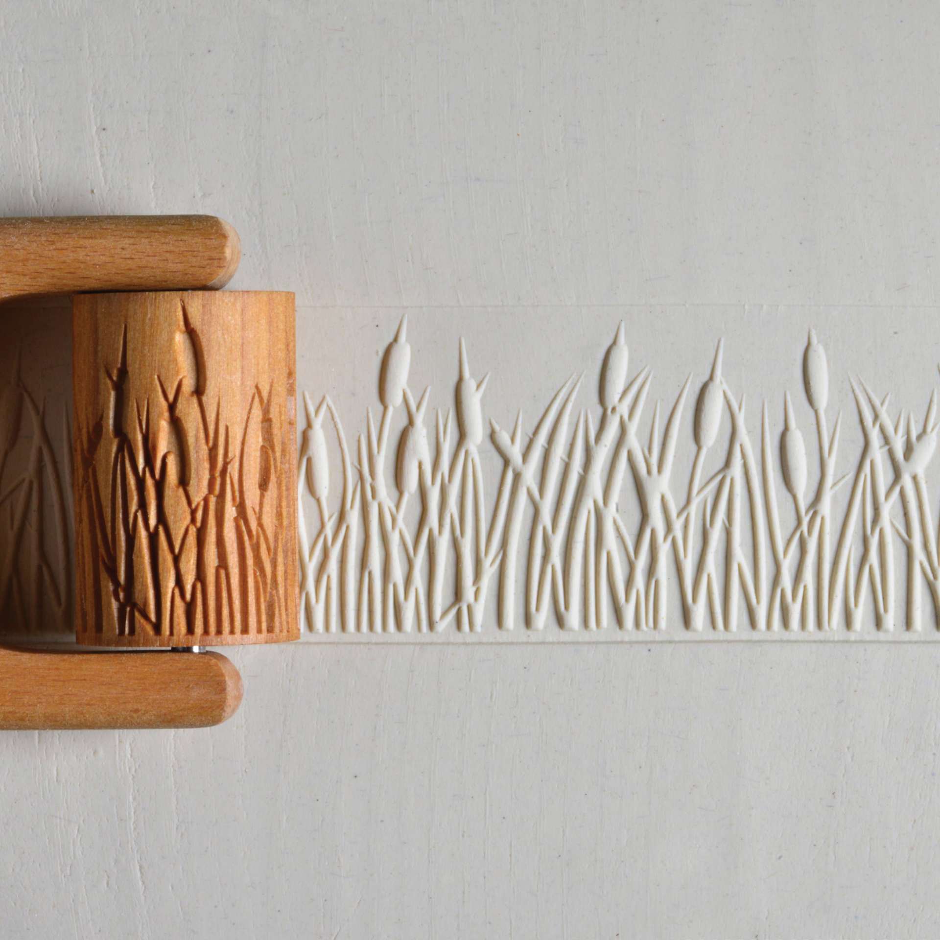 MKM Pottery Tools Large Handle Roller - Cattails applied to clay
