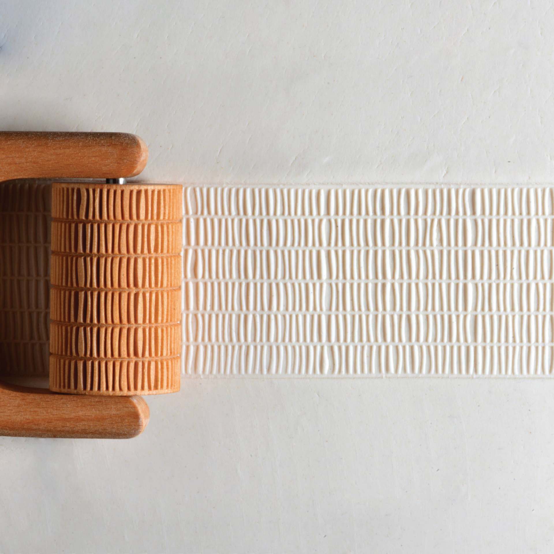 MKM Pottery Tools Large Handle Roller - Layered Lines applied to clay
