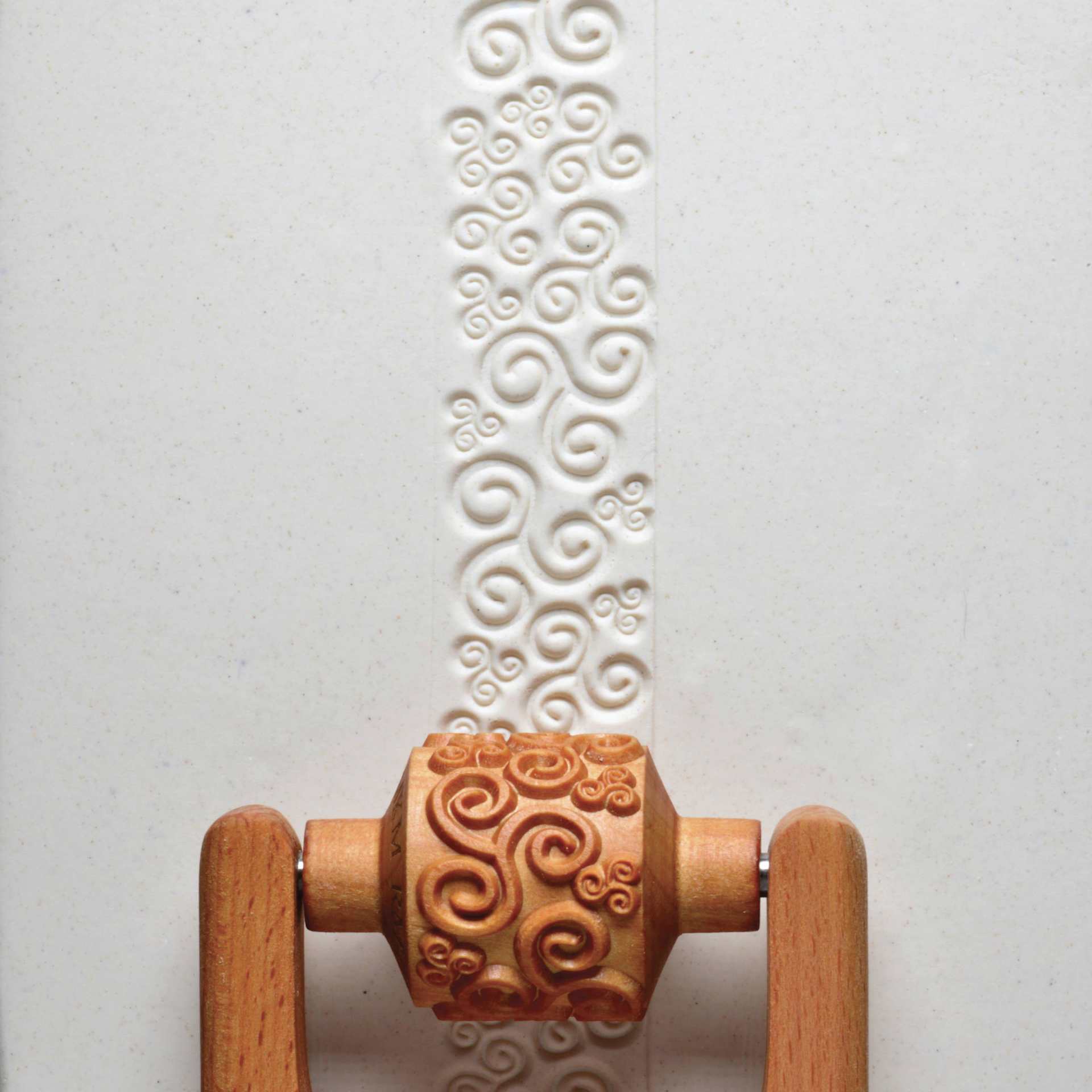 MKM Pottery Tools Medium Handle Roller - Tri Spirals applied to clay
