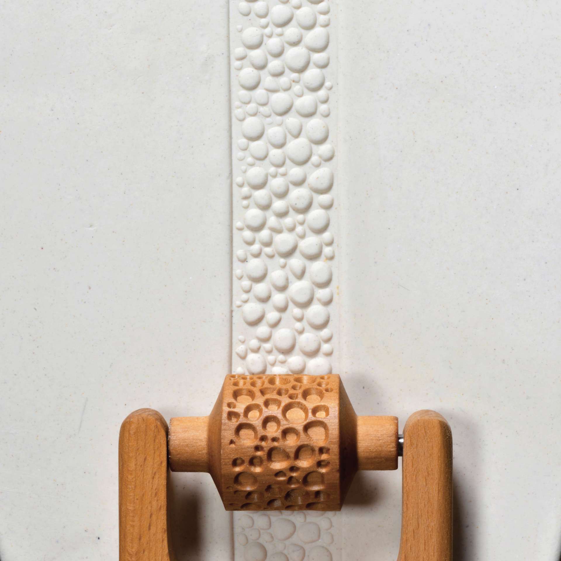 MKM Pottery Tools Medium Handle Roller - Cobbles applied to clay