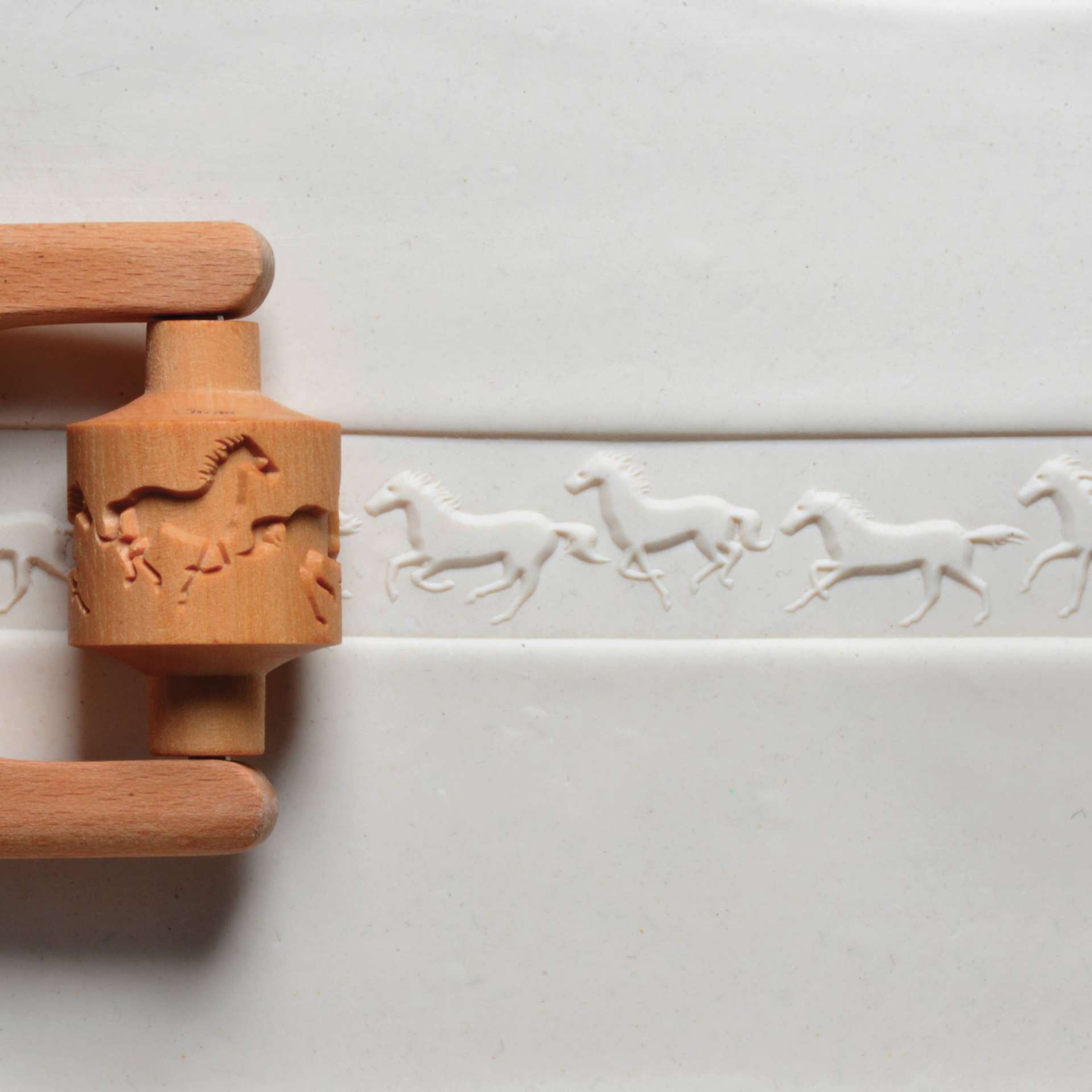 MKM Pottery Tools Medium Handle Roller - Running Horses applied to clay