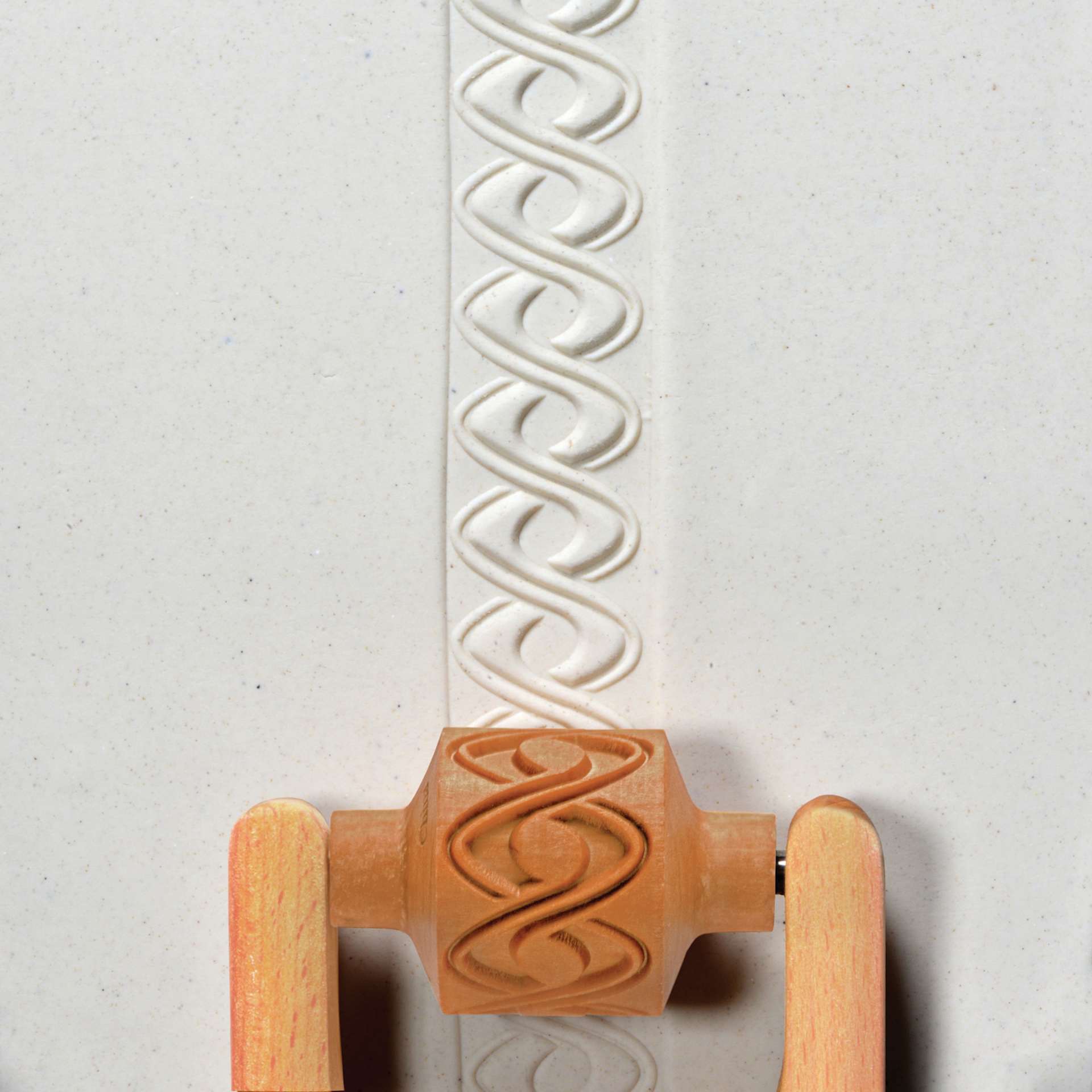 MKM Pottery Tools Medium Handle Roller - Double Helix applied to clay