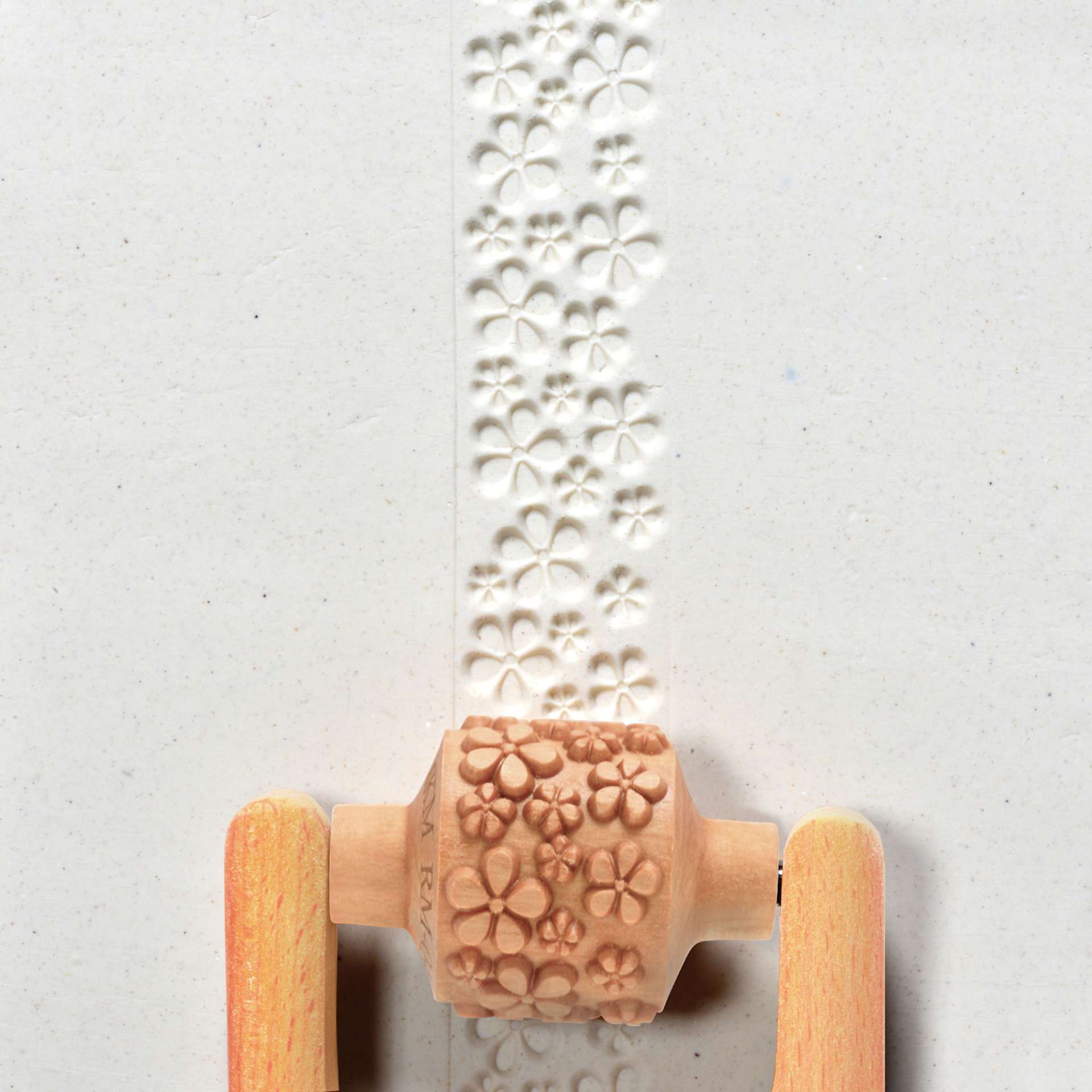 MKM Pottery Tools Medium Handle Roller - Flowers applied to clay