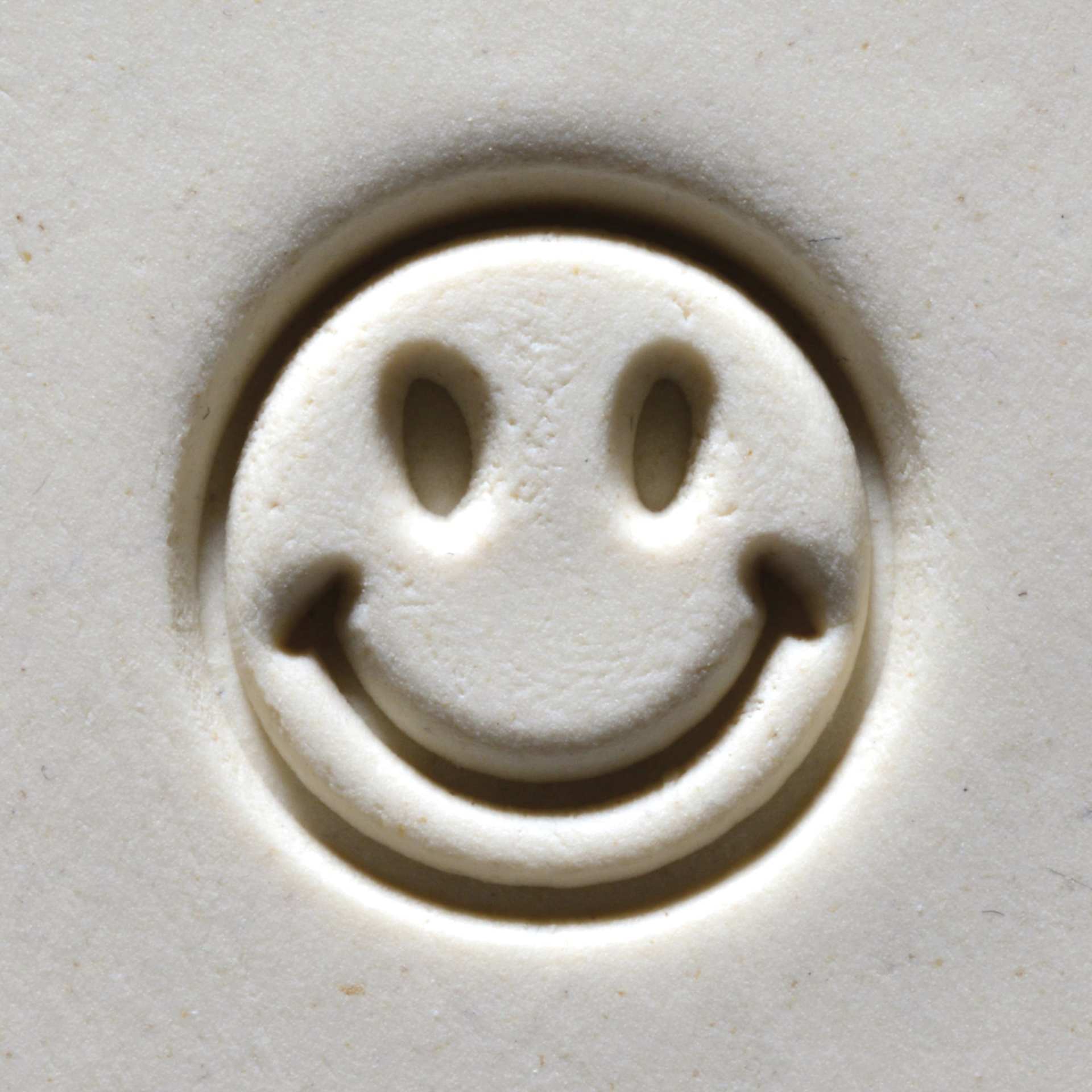 MKM Pottery Tools Medium Round Stamp - SCM-201, Smiley Face applied to clay