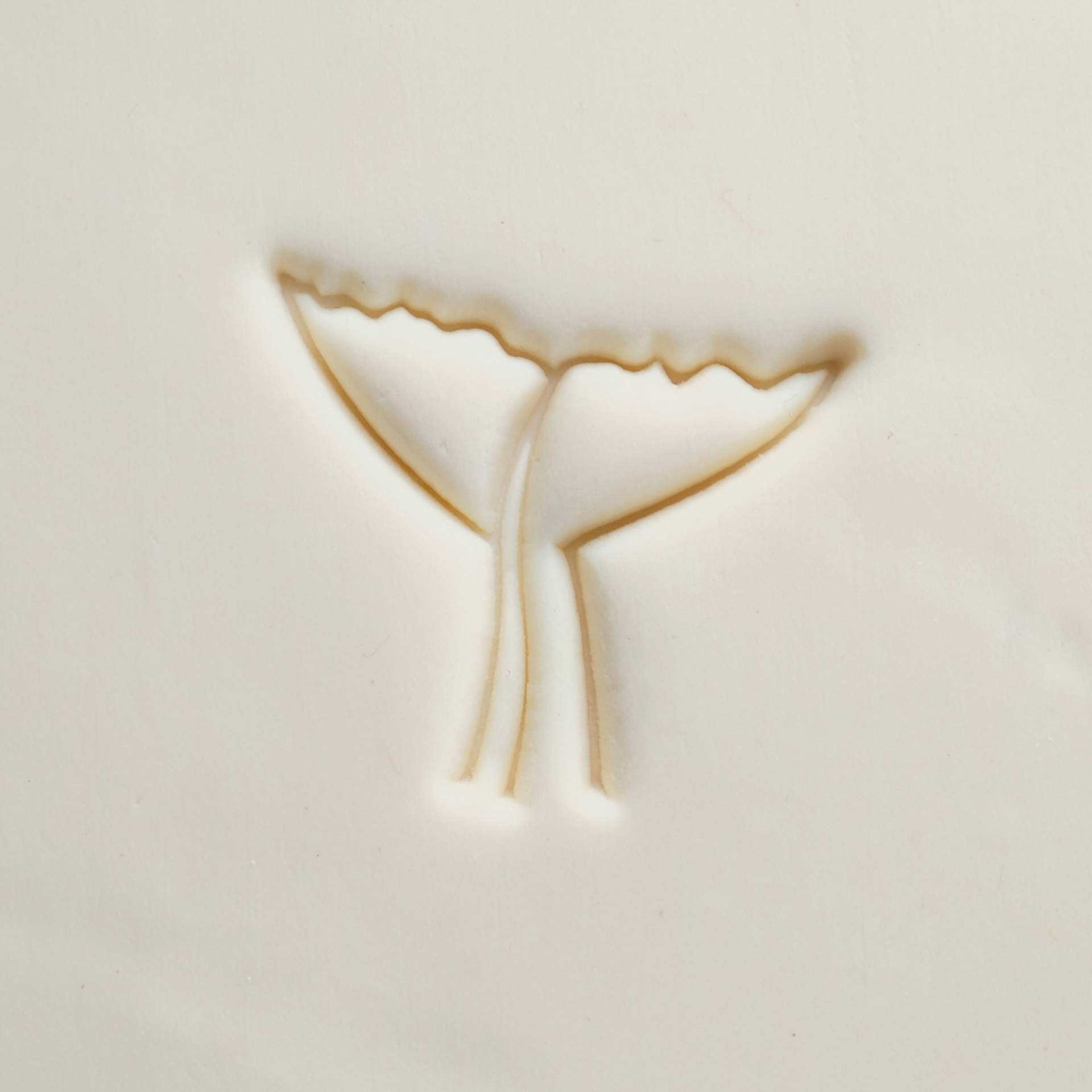 MKM Pottery Tools Large Round Stamp - SCL-170, Whale Tail applied to clay