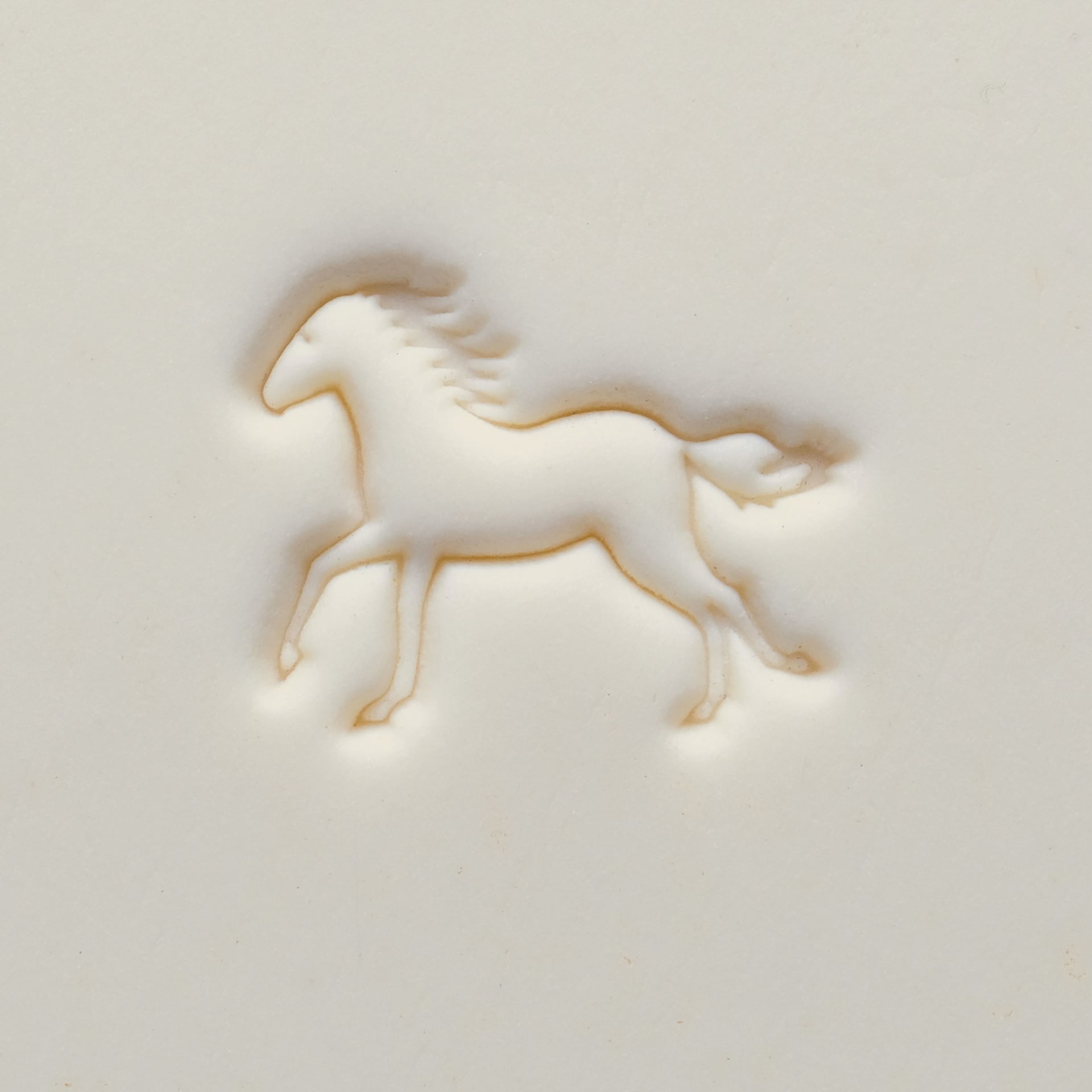MKM Pottery Tools Medium Round Stamp - SCM-307, Galloping Horse applied to clay