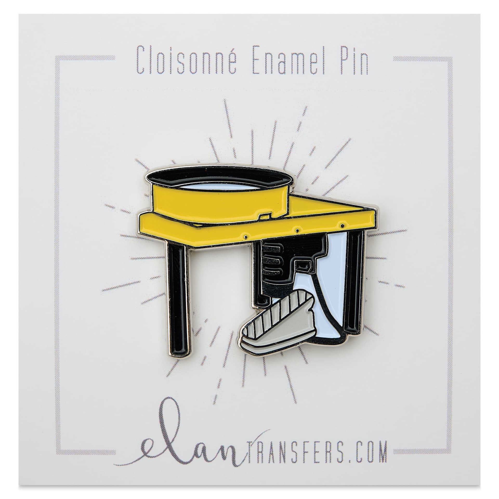 Elan Transfers Enamel Pin - Yellow Pottery Wheel, pinned to front of packaging