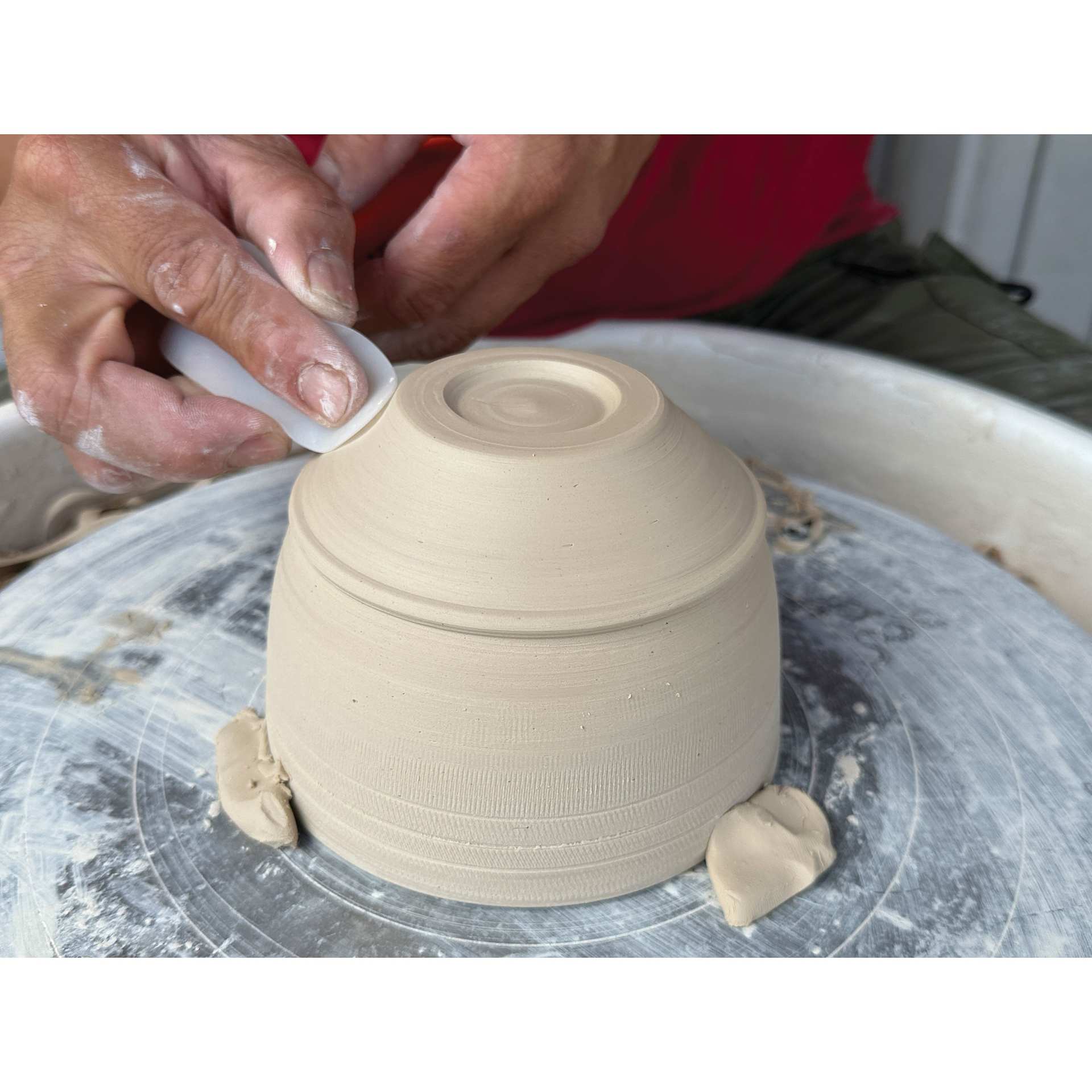 Xiem Silicone Clay Slicker smoothing bottom of clay vessel