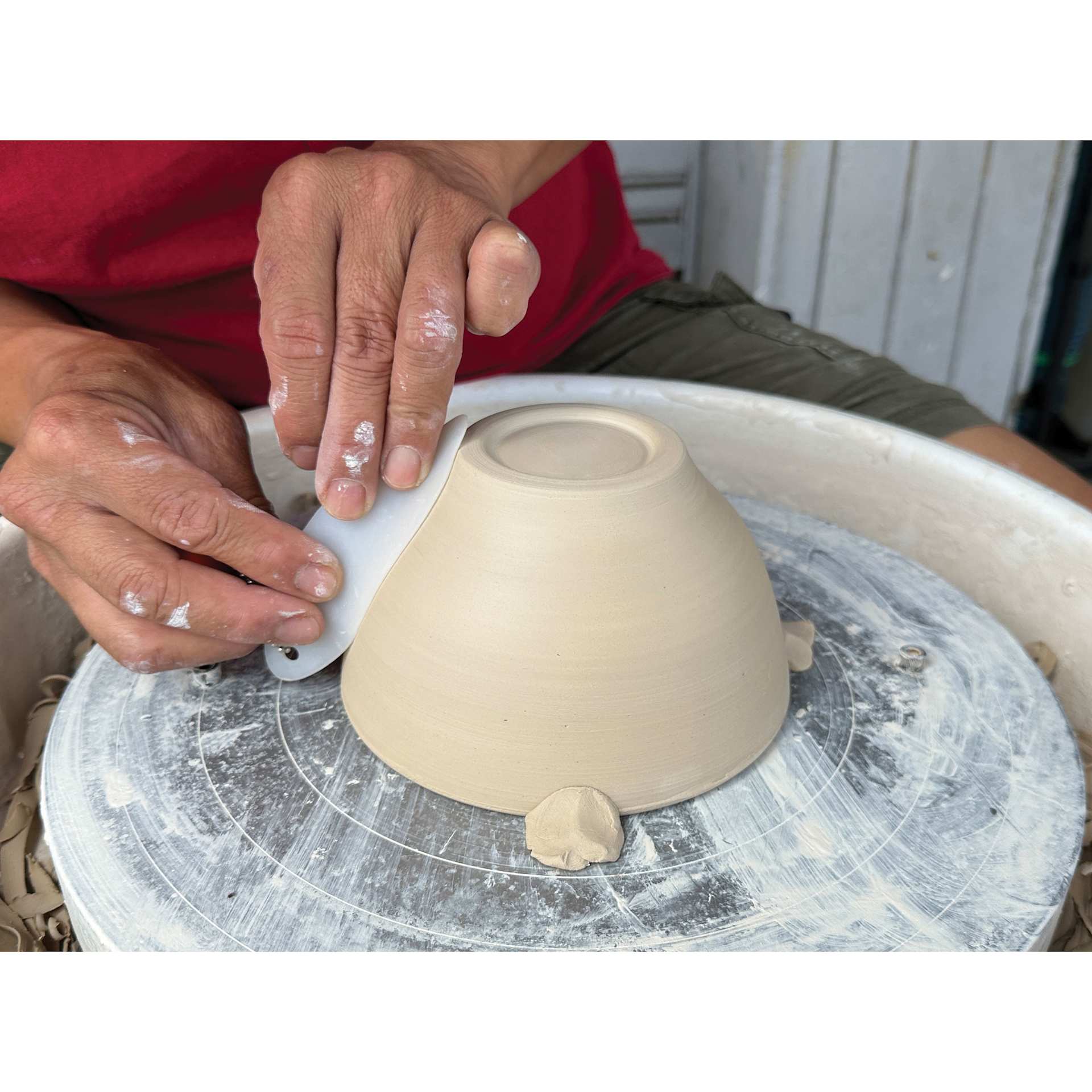 Xiem Silicone Clay Slicker smoothing sides of clay vessel