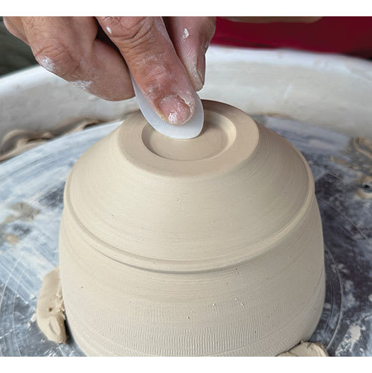 Xiem Silicone Clay Slicker smoothing edges of bottom of clay project