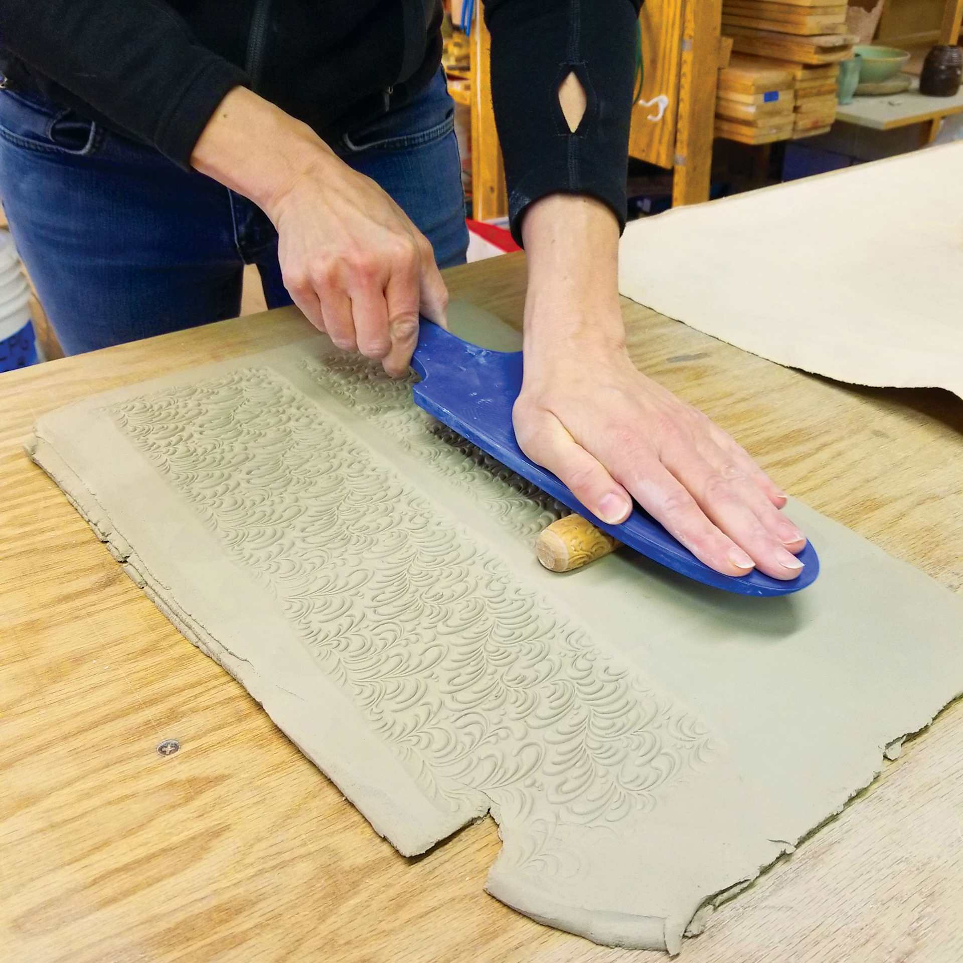 MKM Pottery Tools Roller Board being used to apply roller to clay