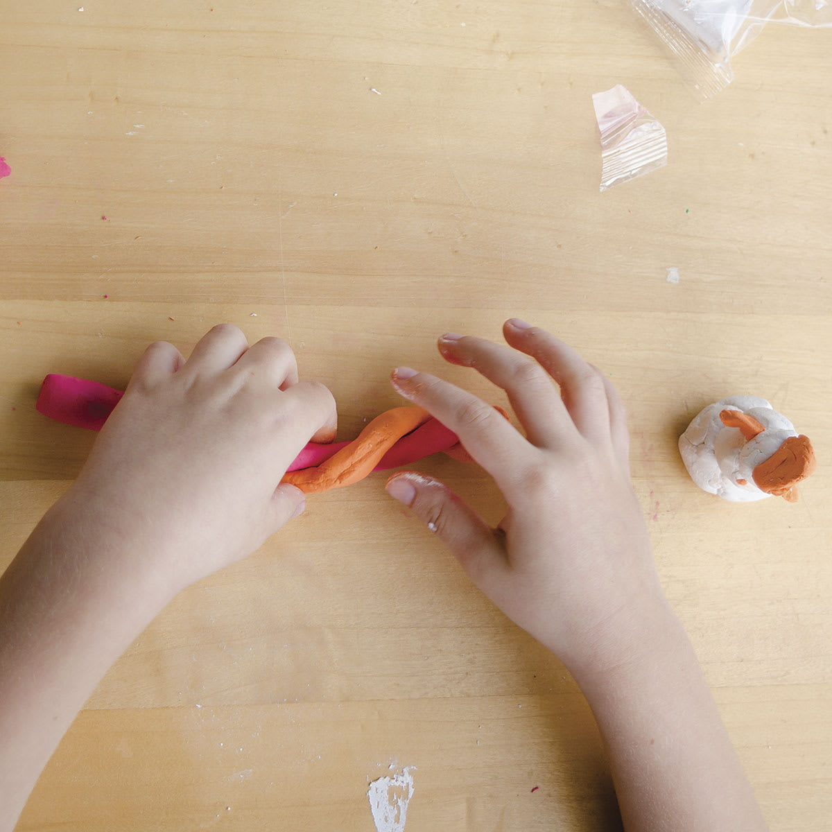 Pebeo Sidewalk Chalk Clay Pail - Child's hands twisting clay colors together