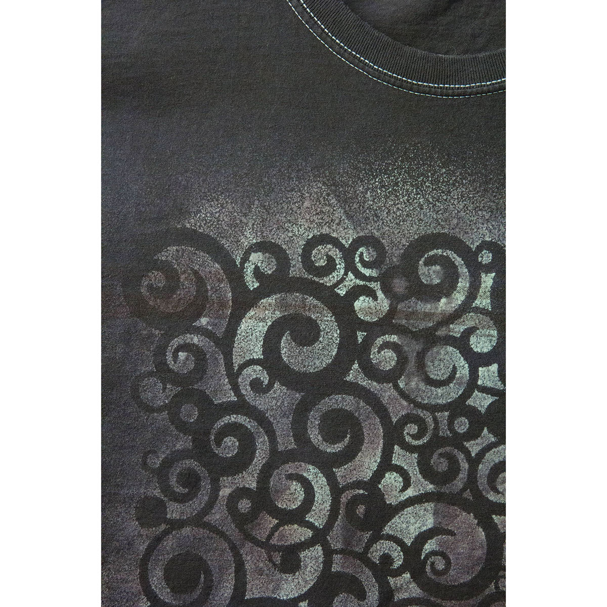 Jacquard deColourant - Example of stenciled swirl pattern on black T-shirt