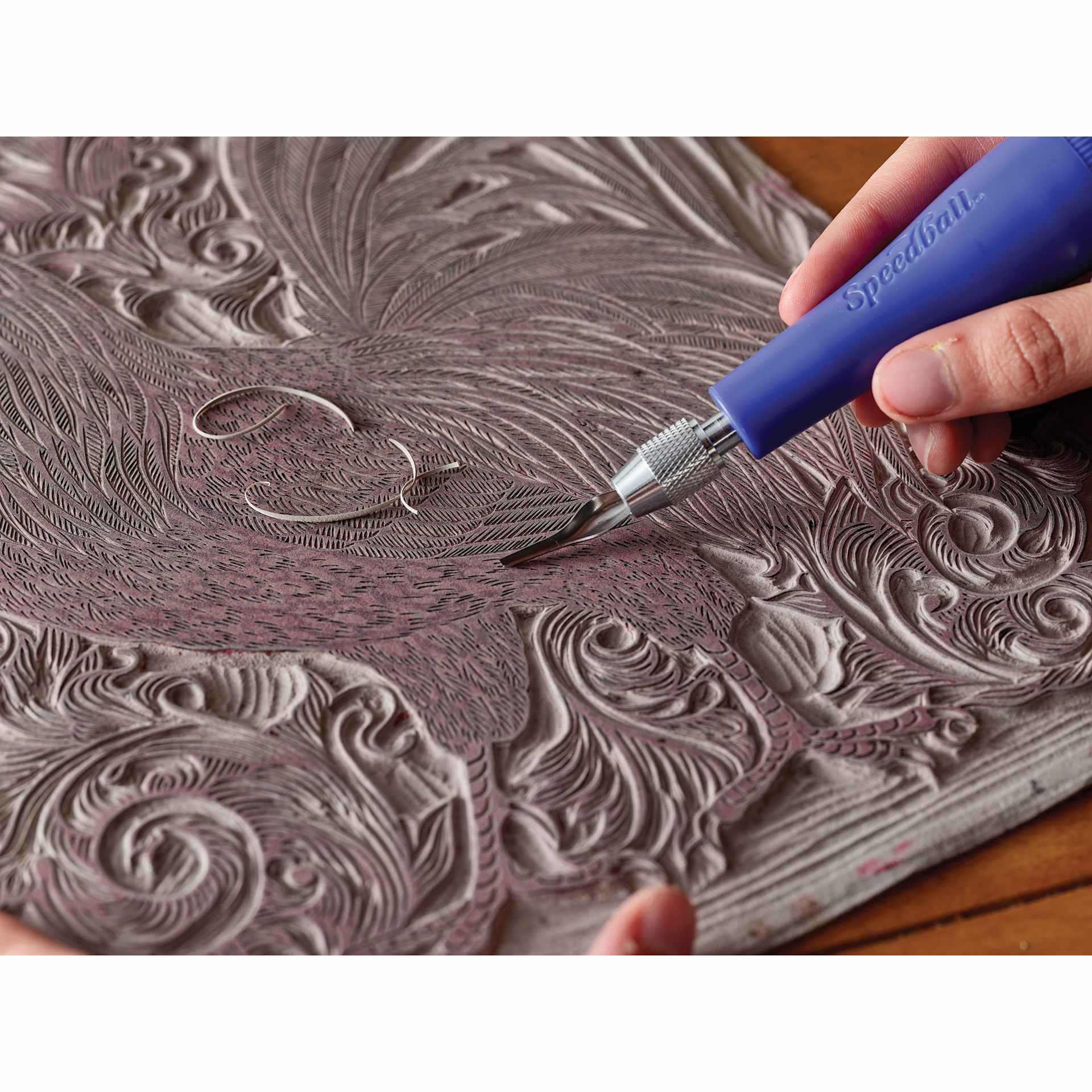 Speedball Red Baron Unmounted Linoleum Sheets being carved by gouge blade