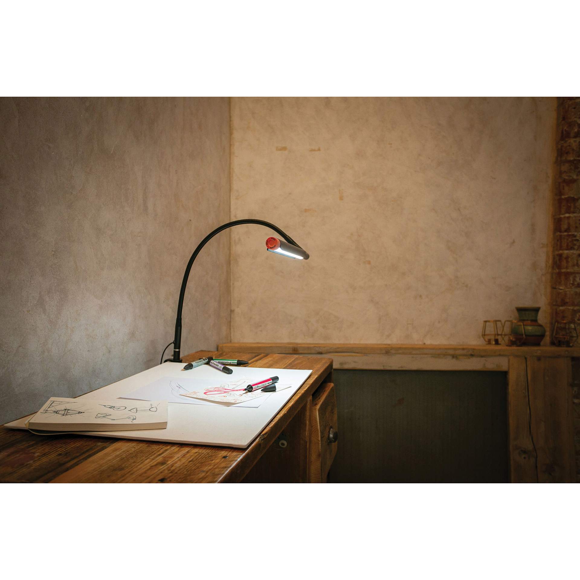 Daylight Techne 2 Artist & Drafting Lamp - Black and Orange, attached to a desk
