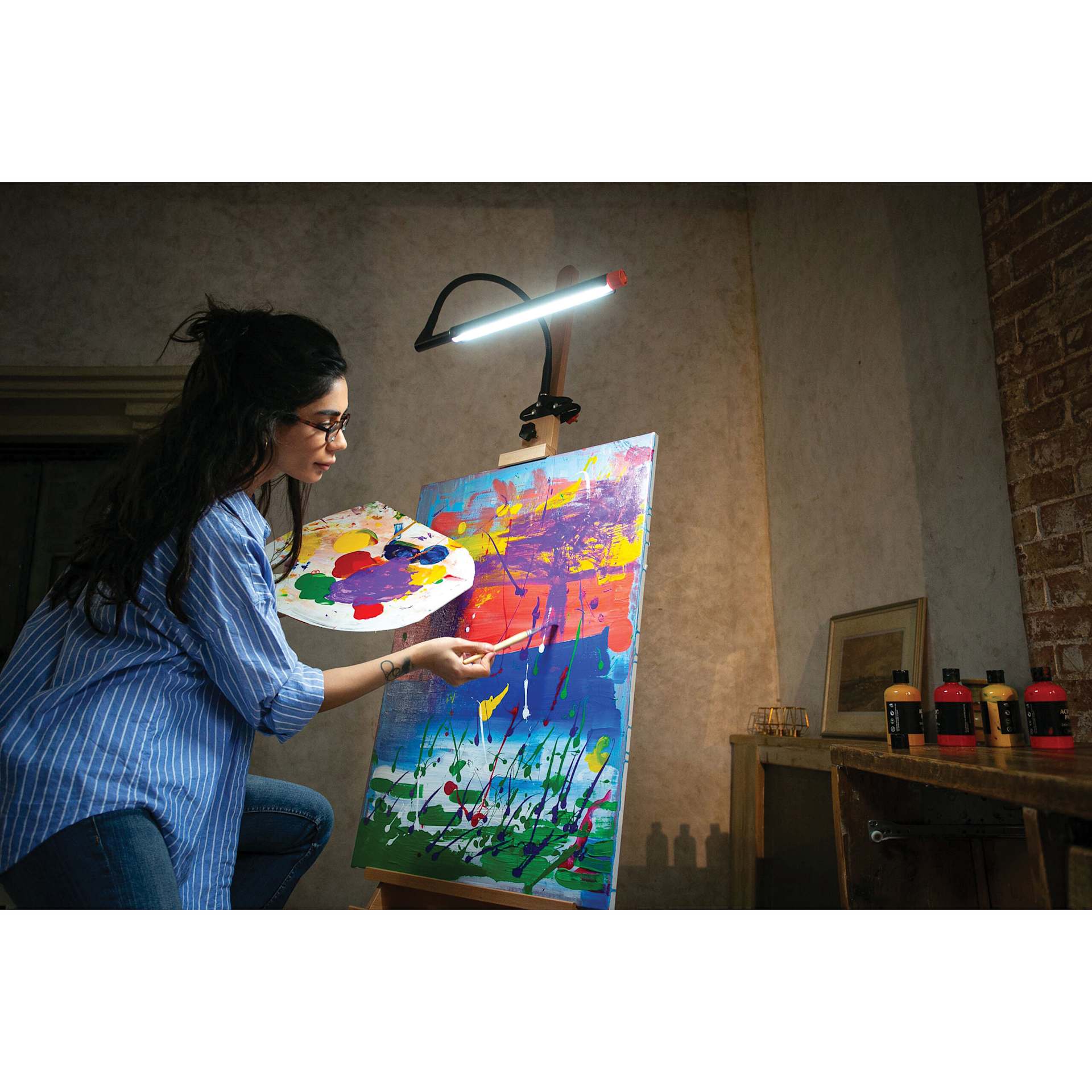 Daylight Techne 2 Artist & Drafting Lamp - Black and Orange, on an easel, in use