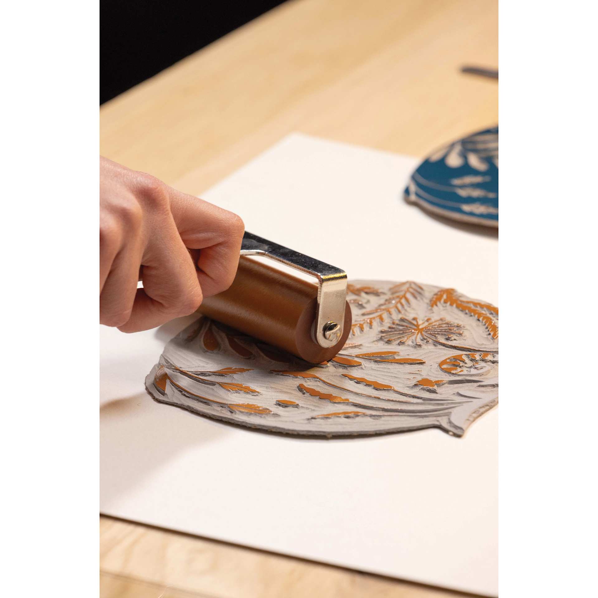 Pebeo Lino Ink - Natural Sienna, 80 ml Tube being applied to carving with brayer