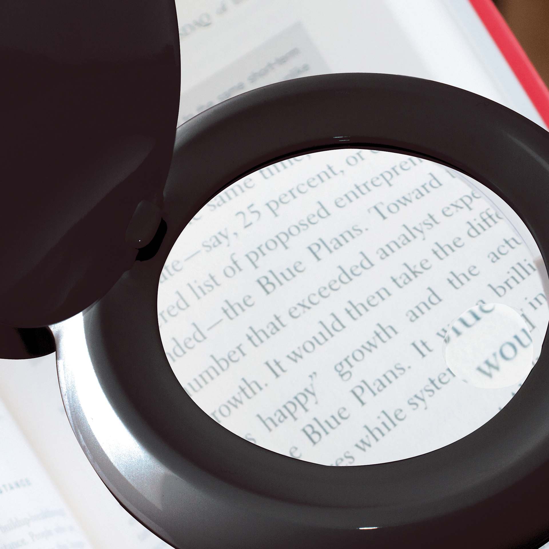 OttLite Space-Saving LED Magnifier Desk Lamp - Black, in-use with a book
