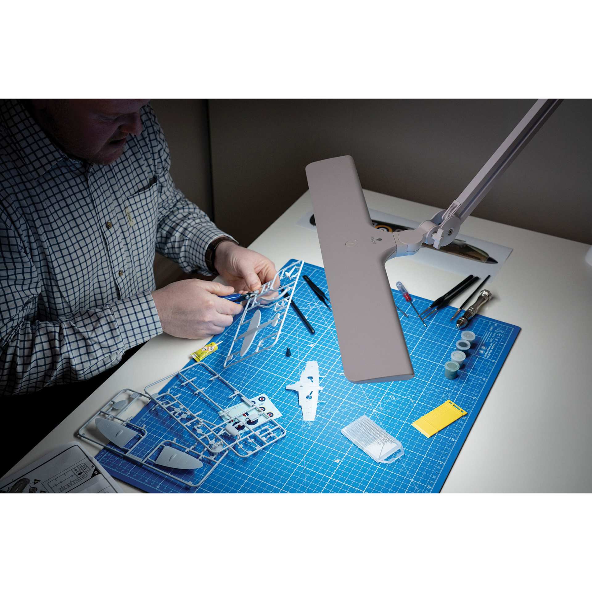 Daylight Lumi Task Lamp - White, in use over a desk