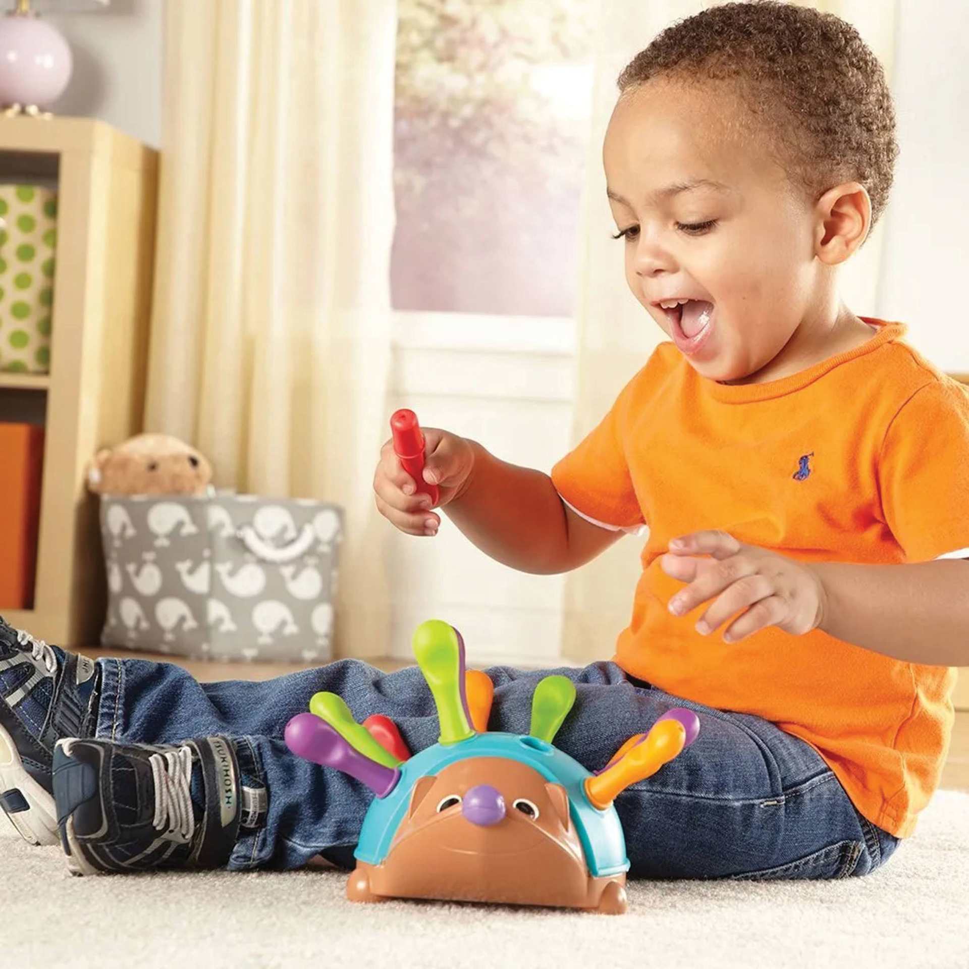 Child Playing With Spike the Fine Motor Hedgehog