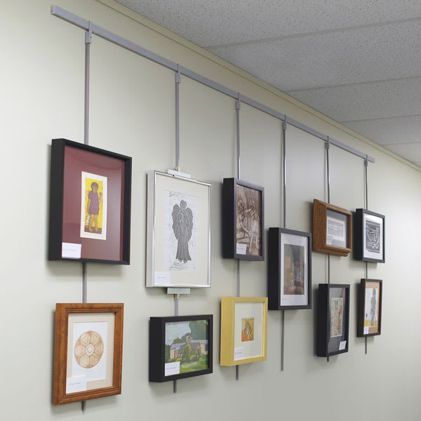 Walker System Rod Sleeves - Wall showing multiple pictures hanging on Walker System 