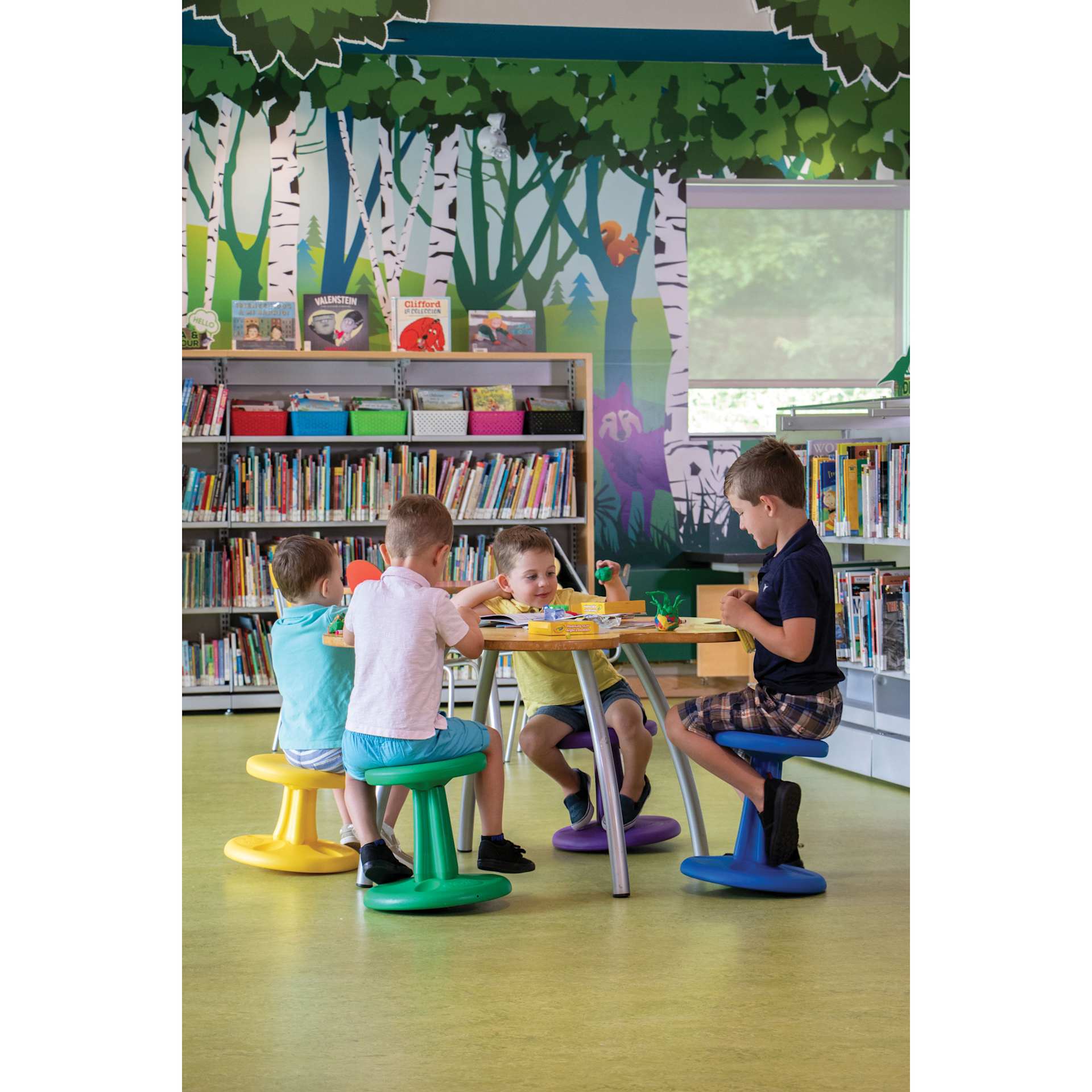 Children in a classroom using the Kore Design Kids Wobble Stools.