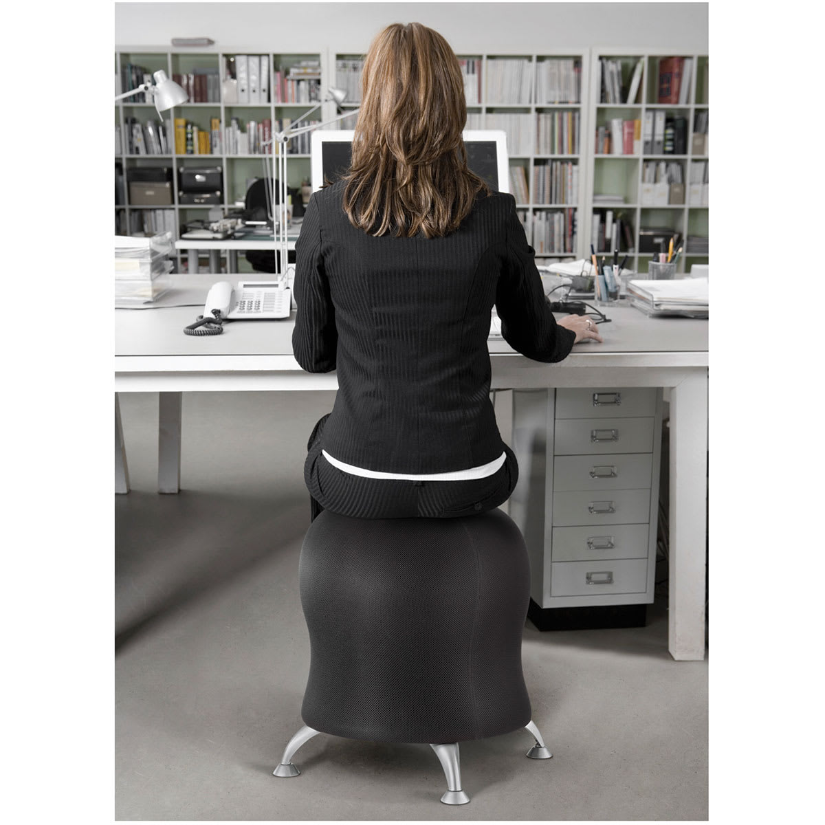 Safco Zenergy Ball Chairs - Back view of woman sitting at desk on black Ball Chair
