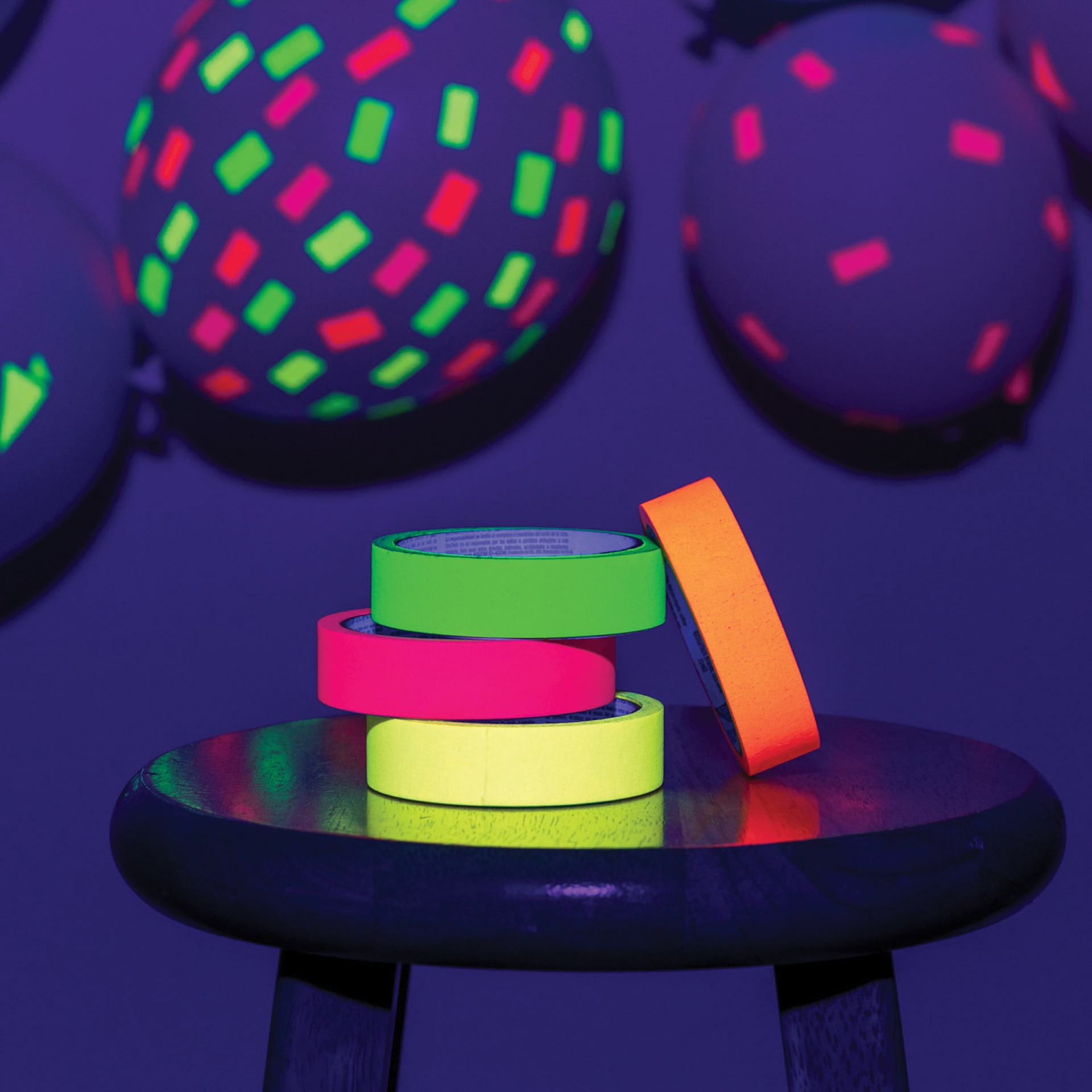 Duck Craft Paper Tapes stacked on table with blacklight