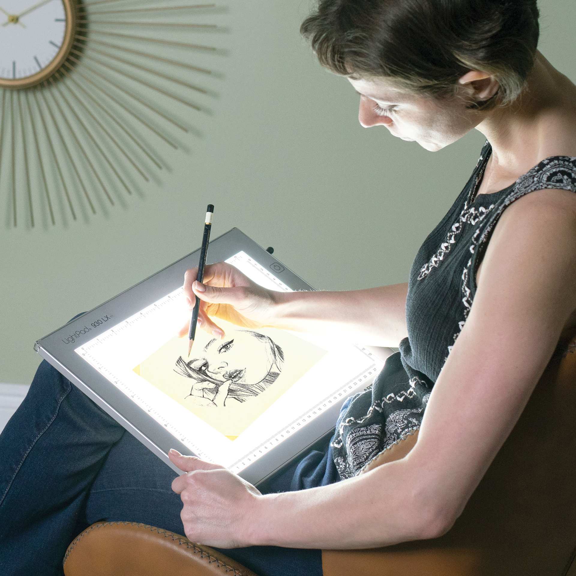 Person using the 9" x 12" Artograph LED LightPad.