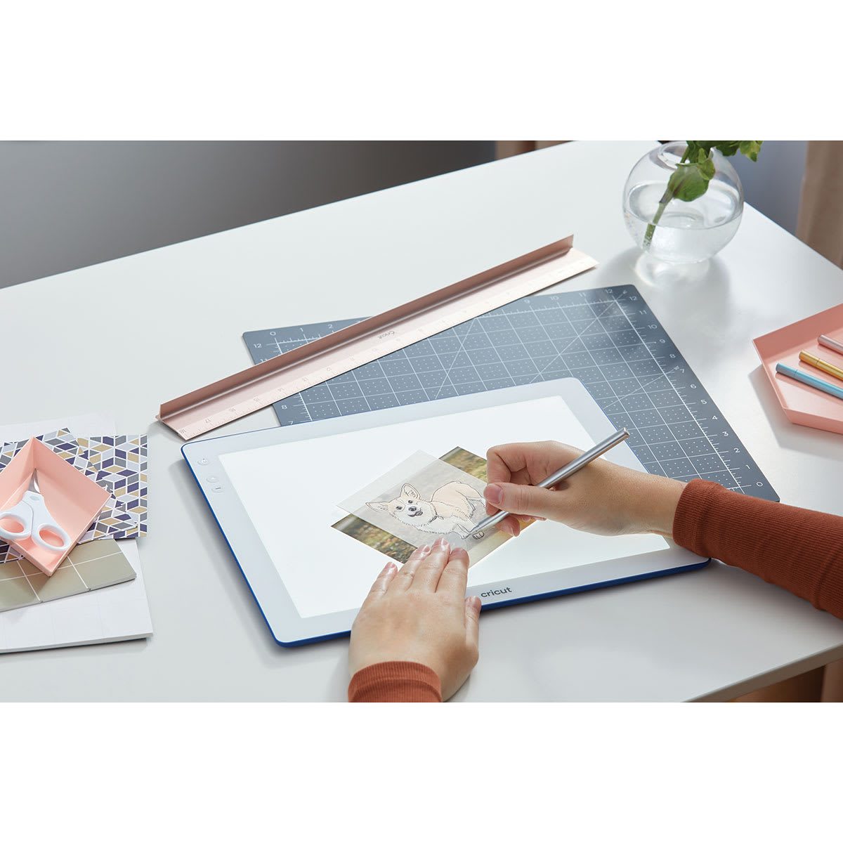 Cricut BrightPad Go - Indigo, 13-1/2" x 11" (Person using BrightPad Go to trace image)