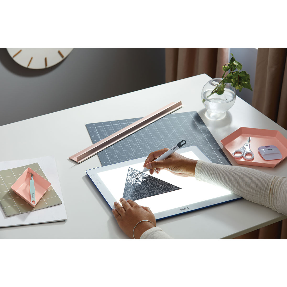 Cricut BrightPad Go - Indigo, 13-1/2" x 11" (Person using BrightPad Go to weed vinyl project)