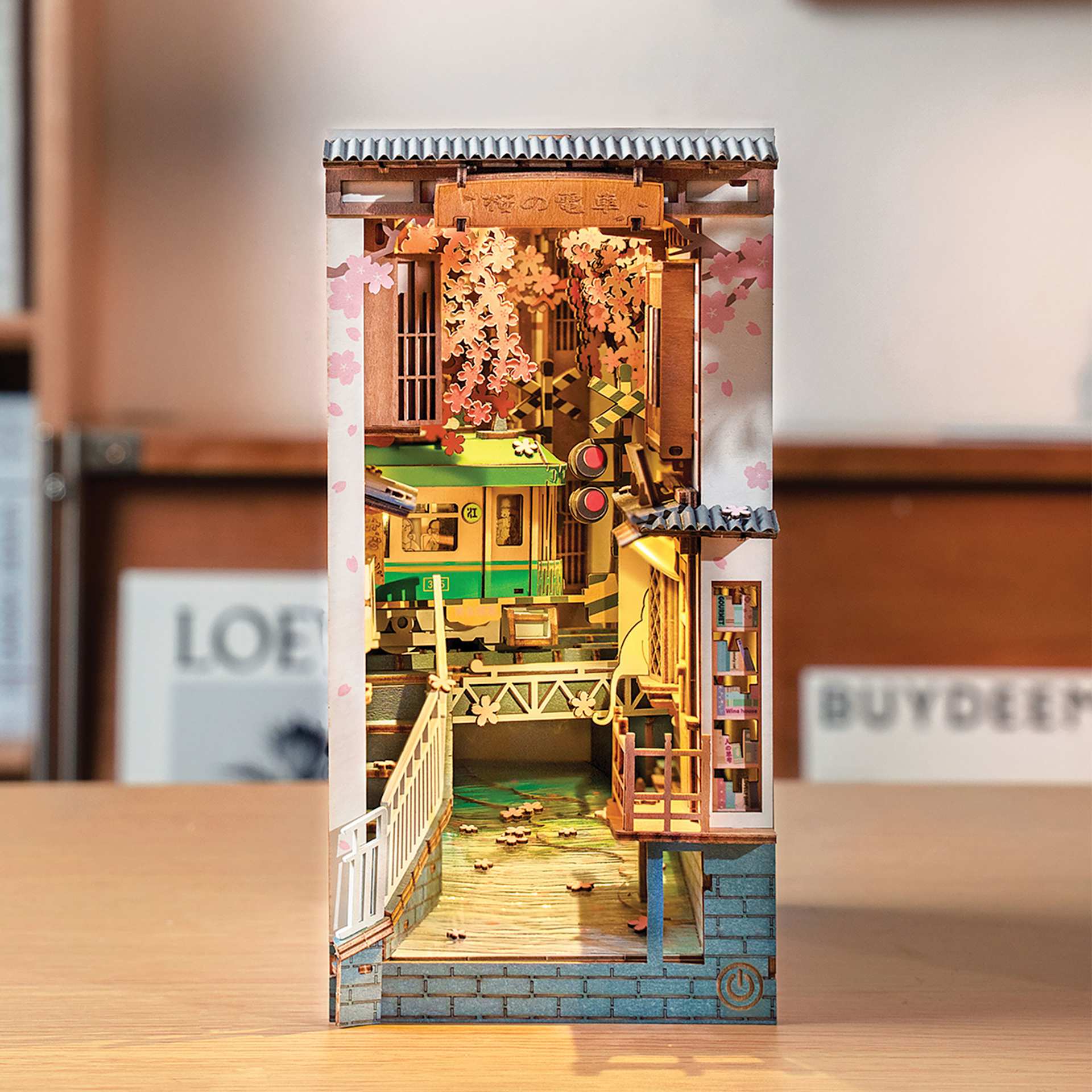 Rolife Sakura Densya DIY Book Nook Kit, constructed kit on a desk