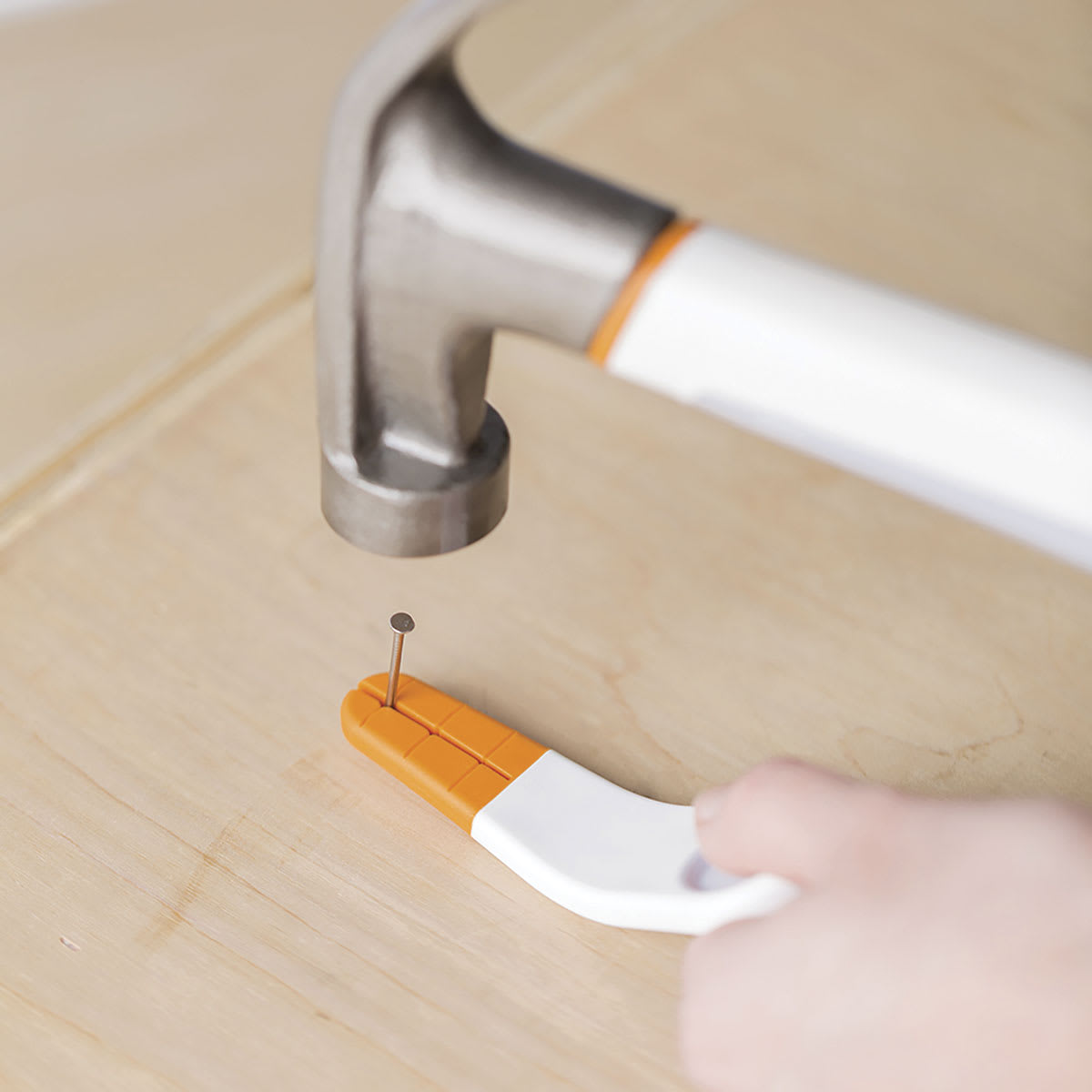 Fiskars Precision Nail Starter - Person hammering nail with tool
