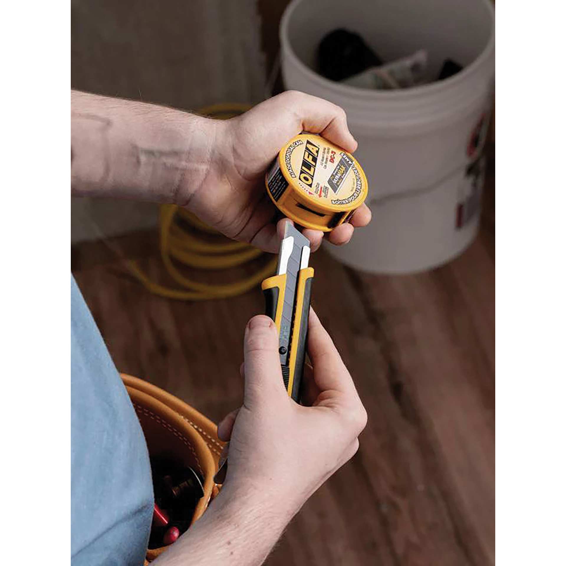 Olfa Pocket-Size Blade Disposal Can, snap blade being inserted into can