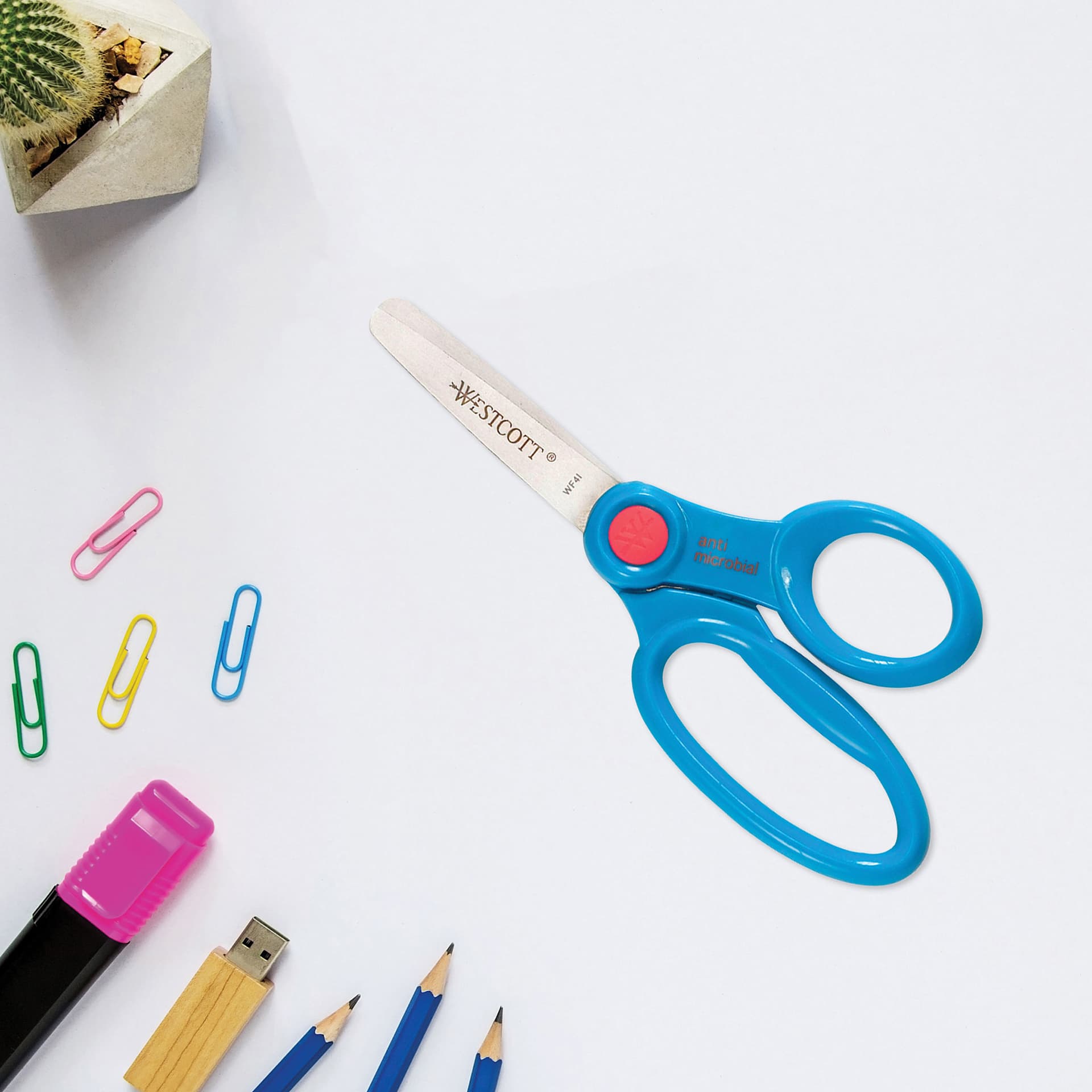 Westcott Anti-Microbial Protection Hard Handle Kids Scissors - 5", Blunt blue variant sitting on table