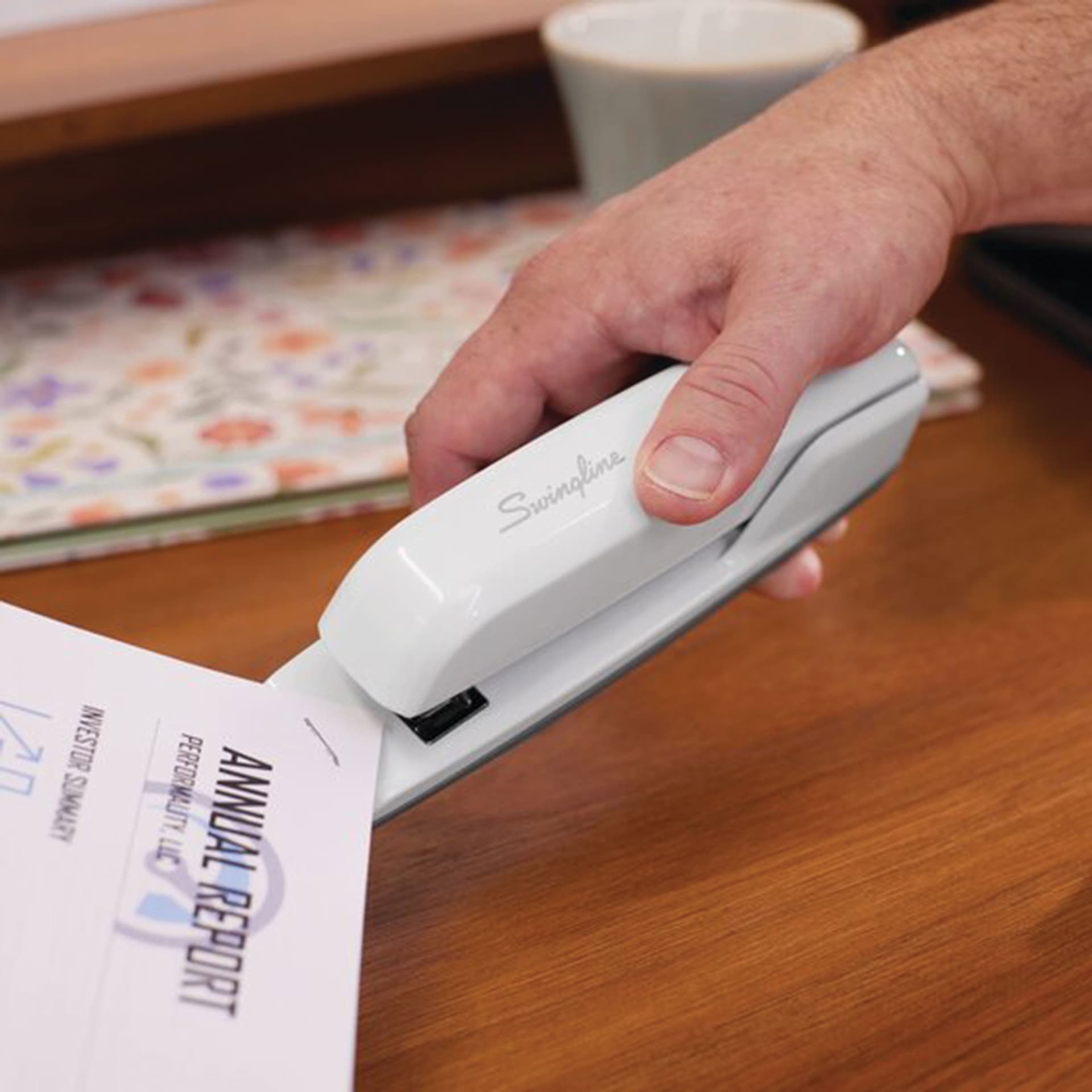 Swingline 747 Business Stapler - Arctic White being held while stapling corner