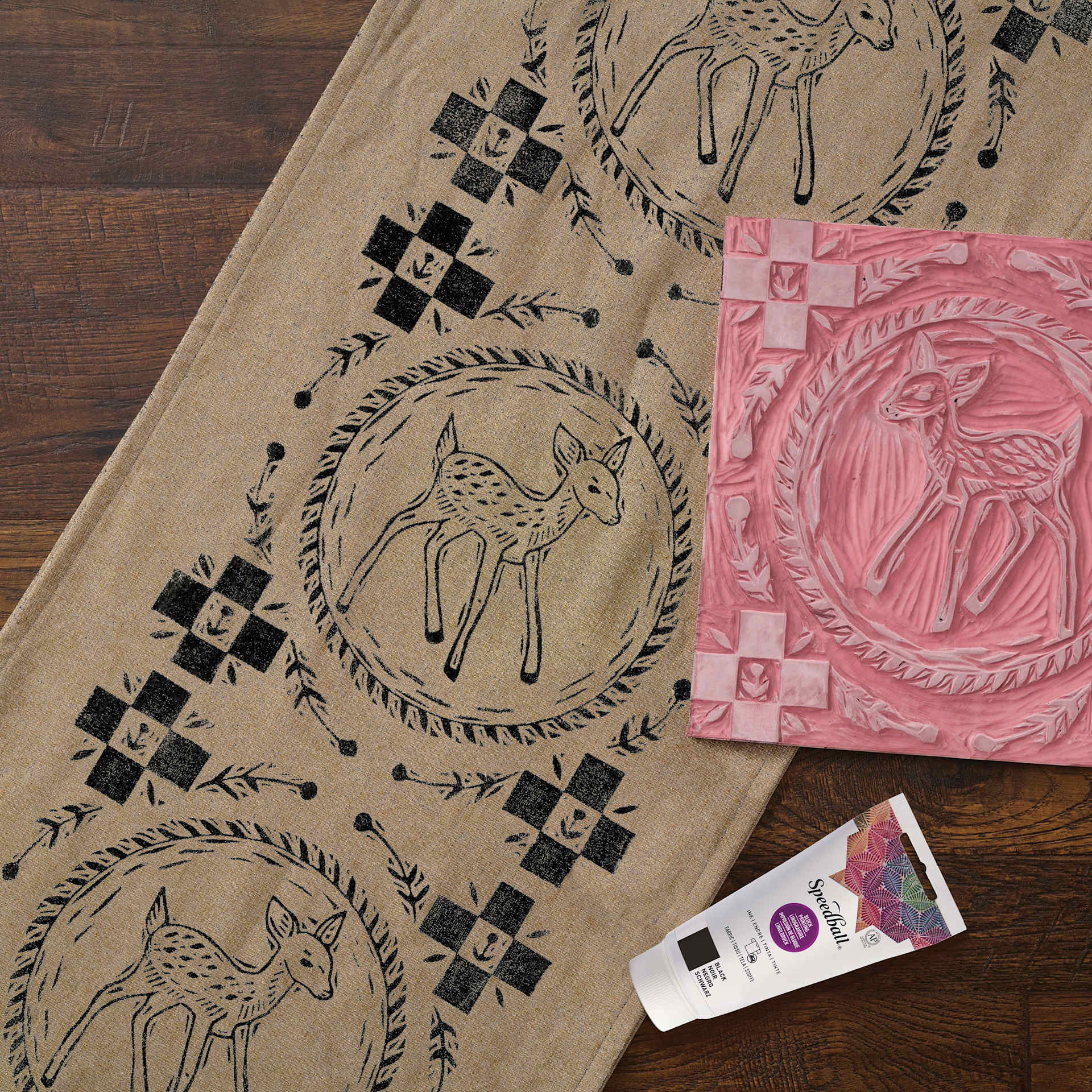 Speedball Speedy Carve Block, carved with fawn design next to block printed fabric and ink