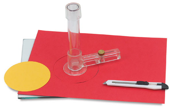 Neil Creativity Cutter - Cutter with circle on red paper and knife nearby
