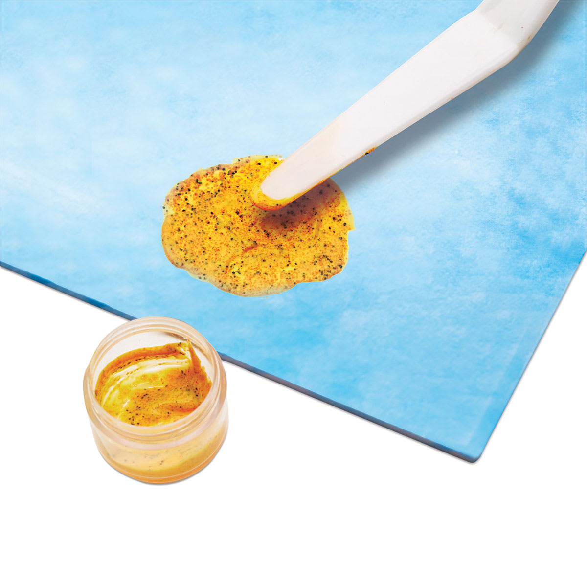 Faber-Castell 3D Art Sand Painting Kit - Closeup of gold sand paint on blue board
