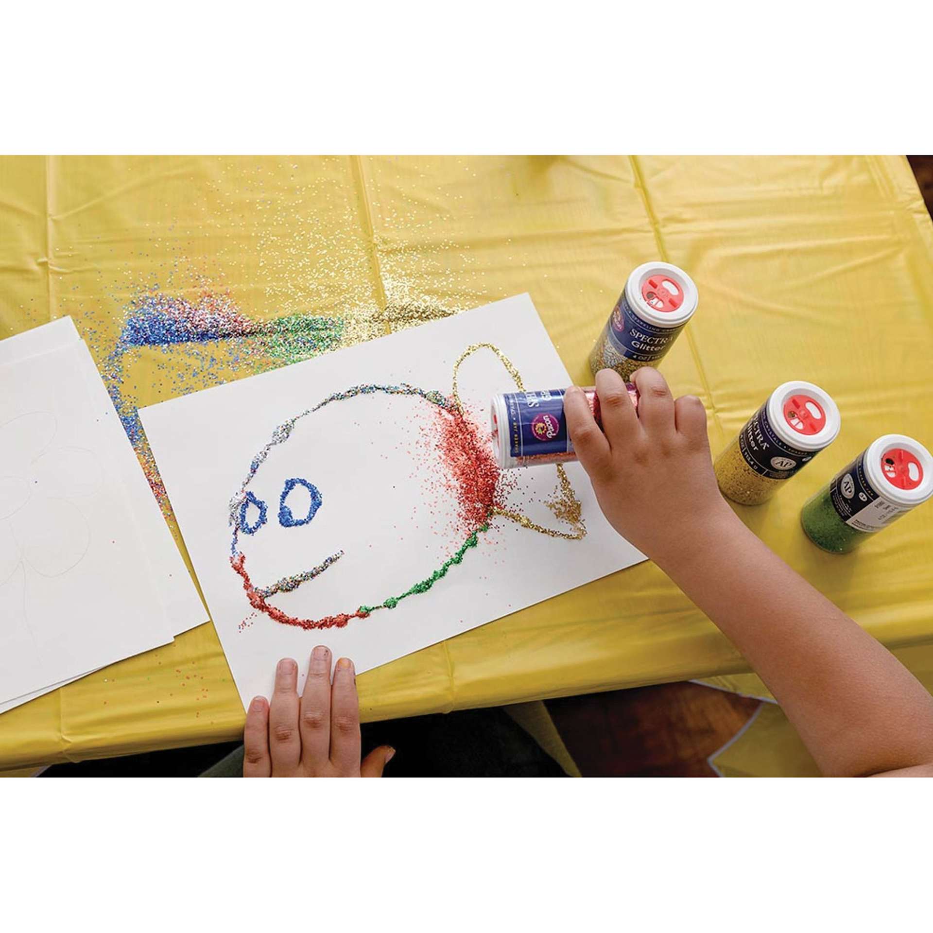 Spectra Sparkling Crystals Glitter (child adding glitter to fish drawing)