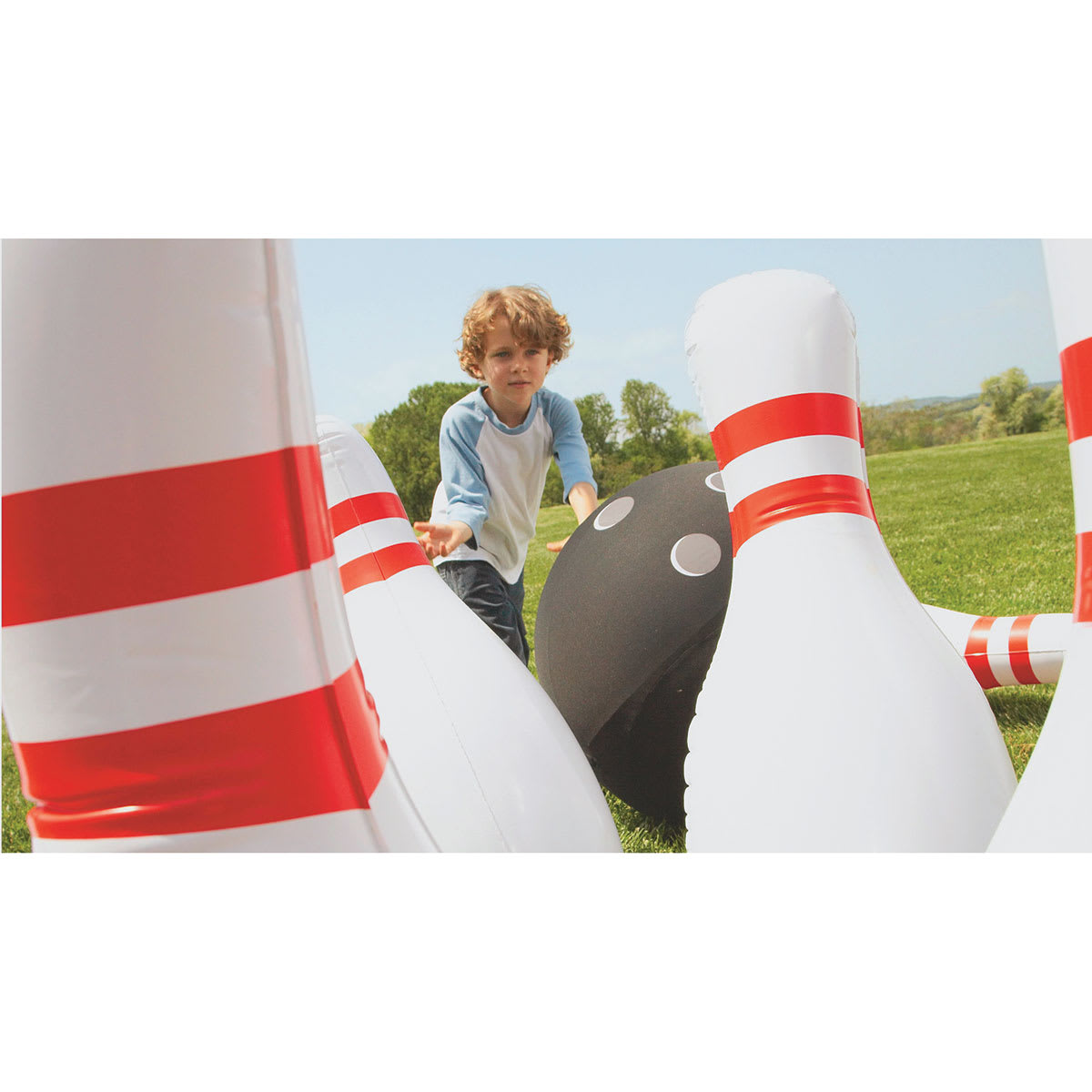 Inflatable Bowling Game - Closeup of pins with child in background
