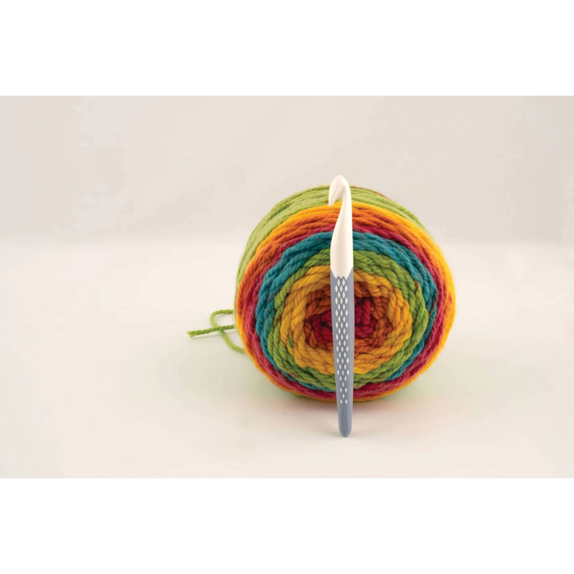 Prym Ergonomics Crochet Hook - Q, 16 mm set beside skein of yarn