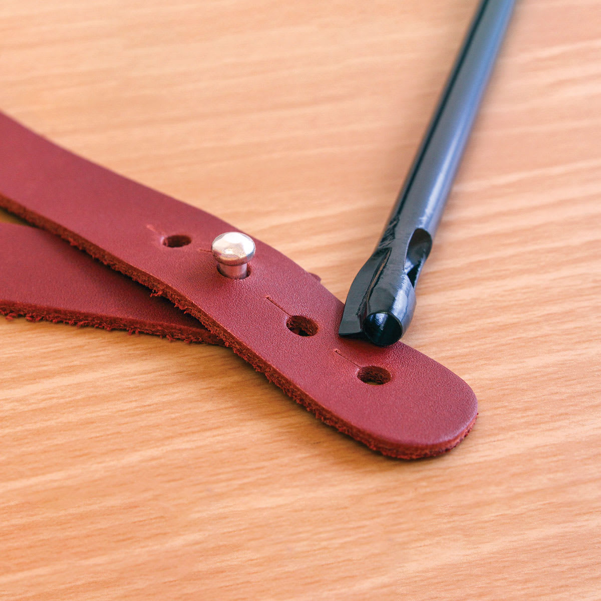 Leather Punch Tools - Closeup of Buttonhole Punch showing results on leather 