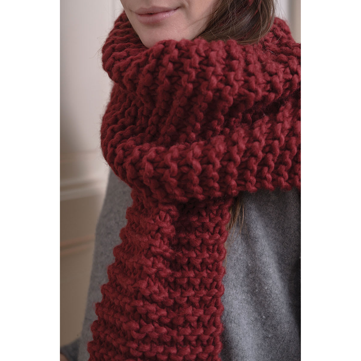 An Italian Story Ora Yarn - Closeup of person wearing Wine color knit scarf
